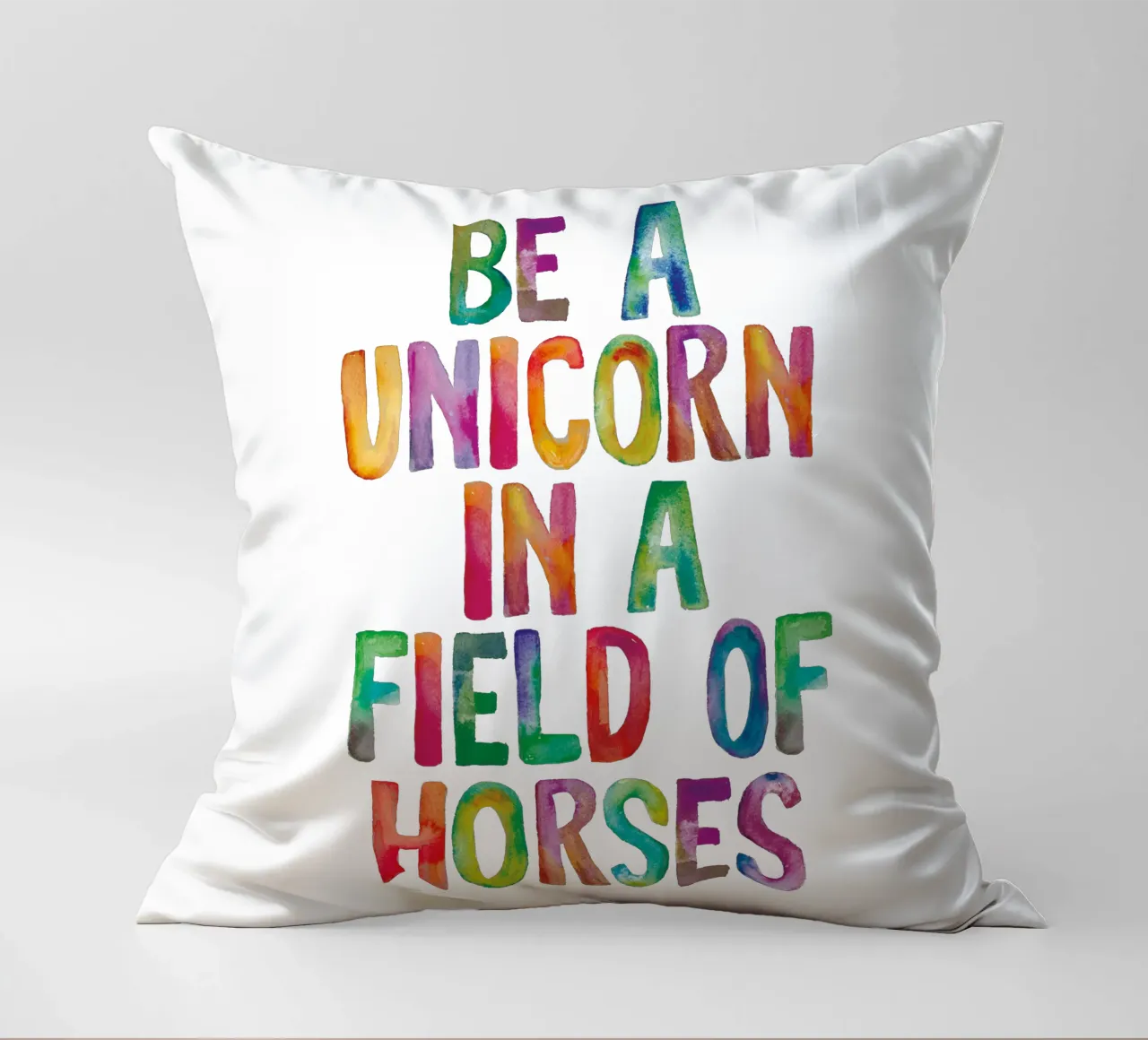 Essere un unicorno in un campo di cavalli: design tipografico arcobaleno cuscino da THE MOTIVATED TYPE
