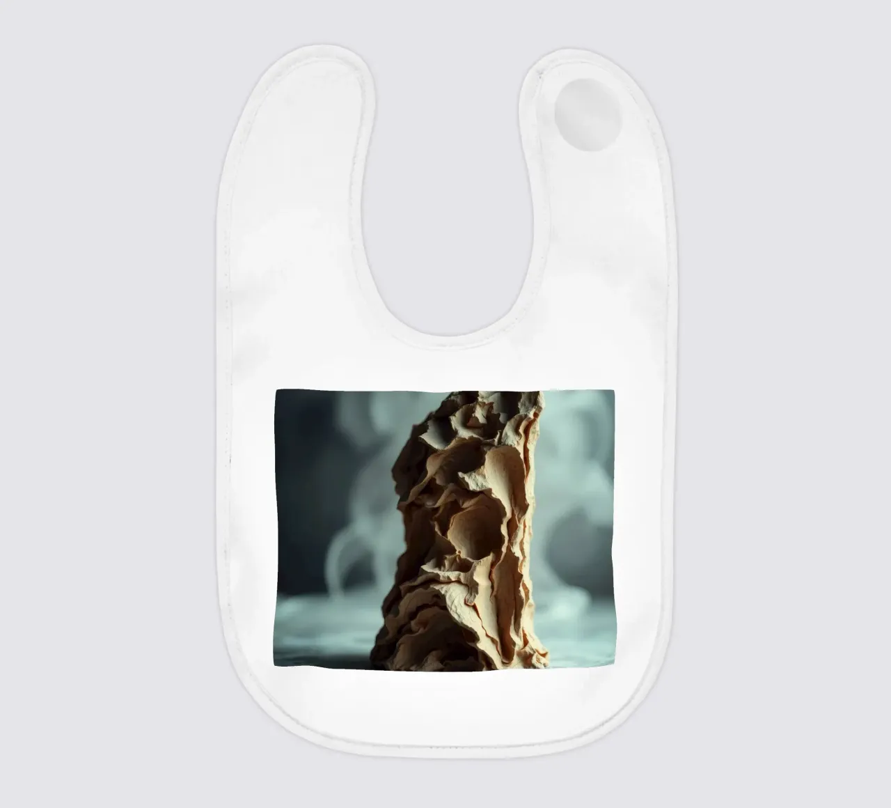 Unique textured sculpture displayed against a soft gray baby bib by DesignDoodle