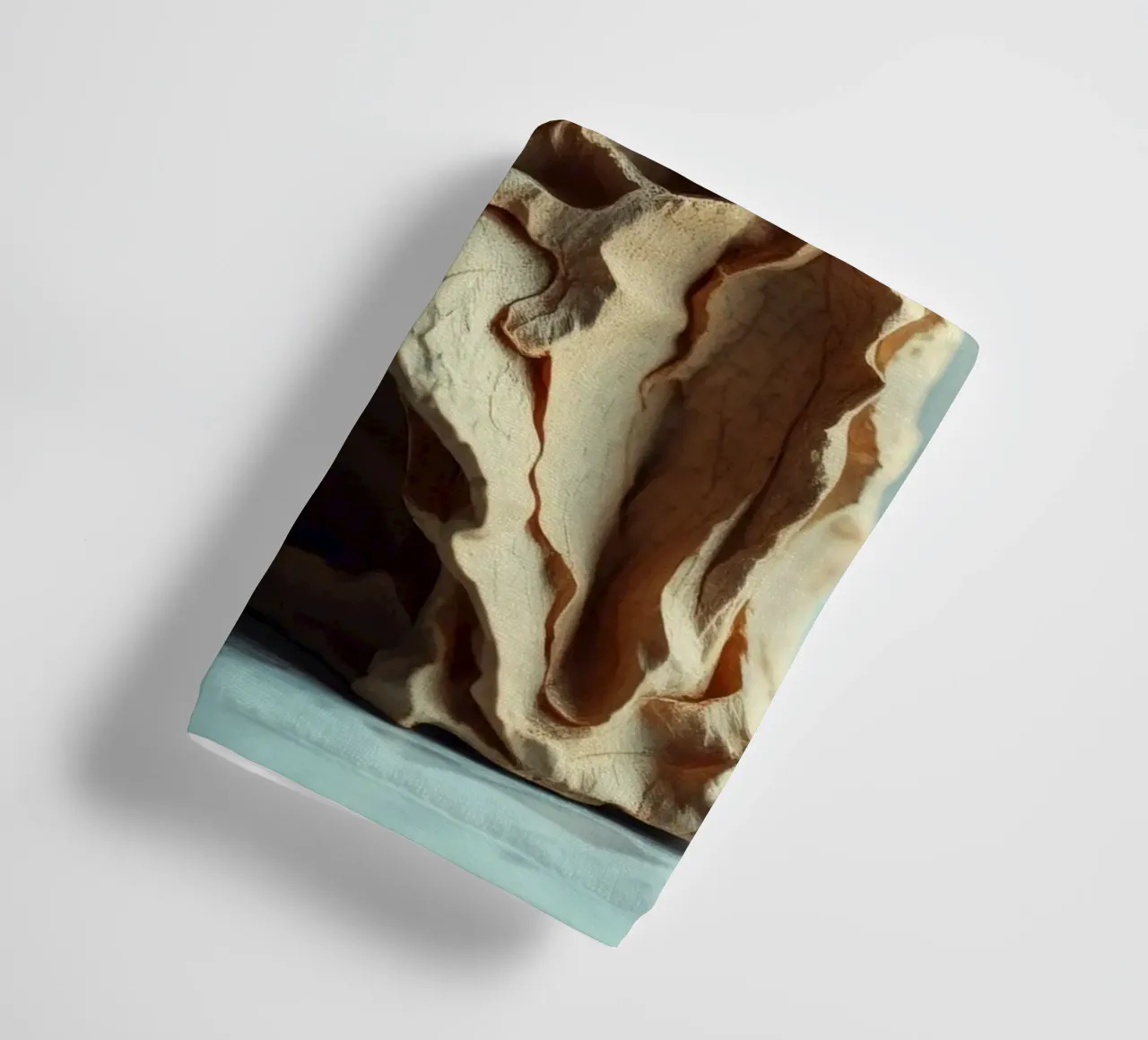 Unique textured sculpture displayed against a soft gray towel by DesignDoodle