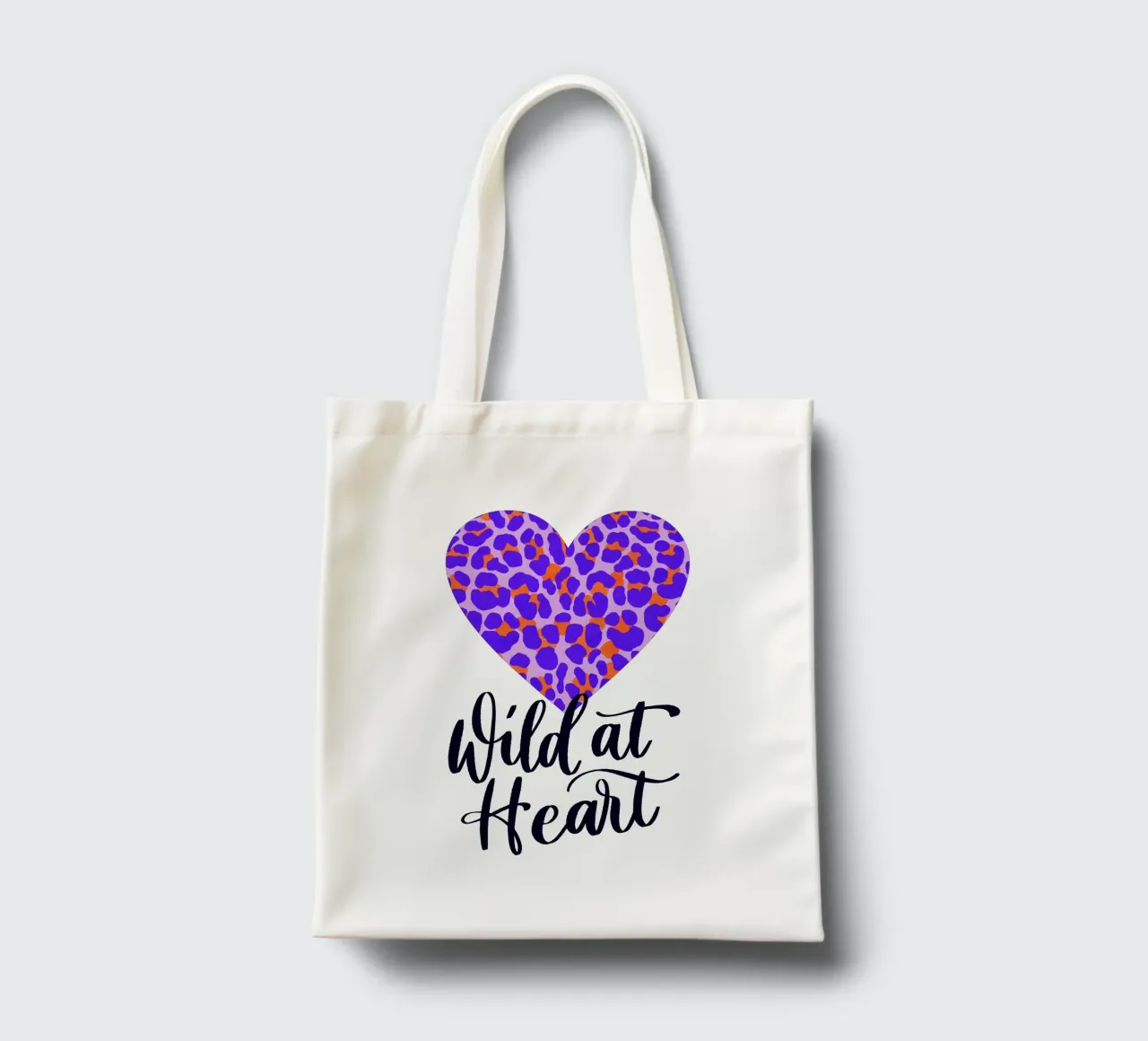 Wild at Heart. Brush calligraphy with leo print pattern tote bag by CalliLetters