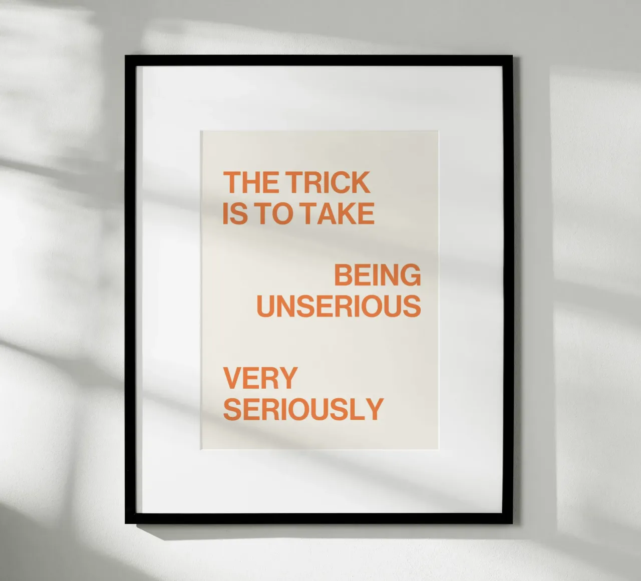 The trick is to take being unserious very seriously quote poster with wooden frame by Paigaam Studio