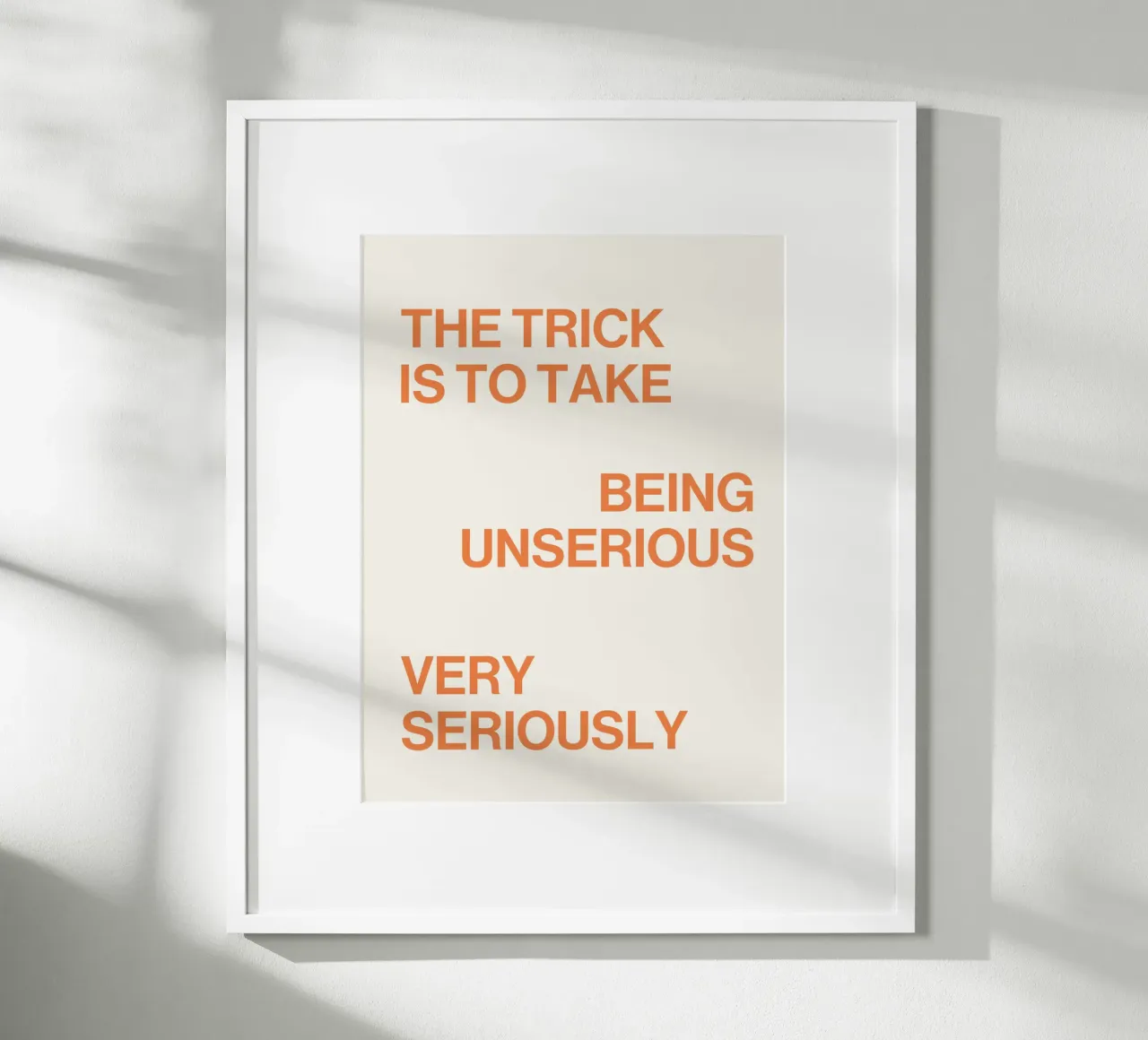 The trick is to take being unserious very seriously quote poster with wooden frame by Paigaam Studio