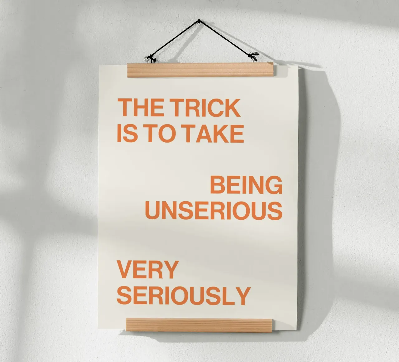 The trick is to take being unserious very seriously quote poster with wooden frame by Paigaam Studio