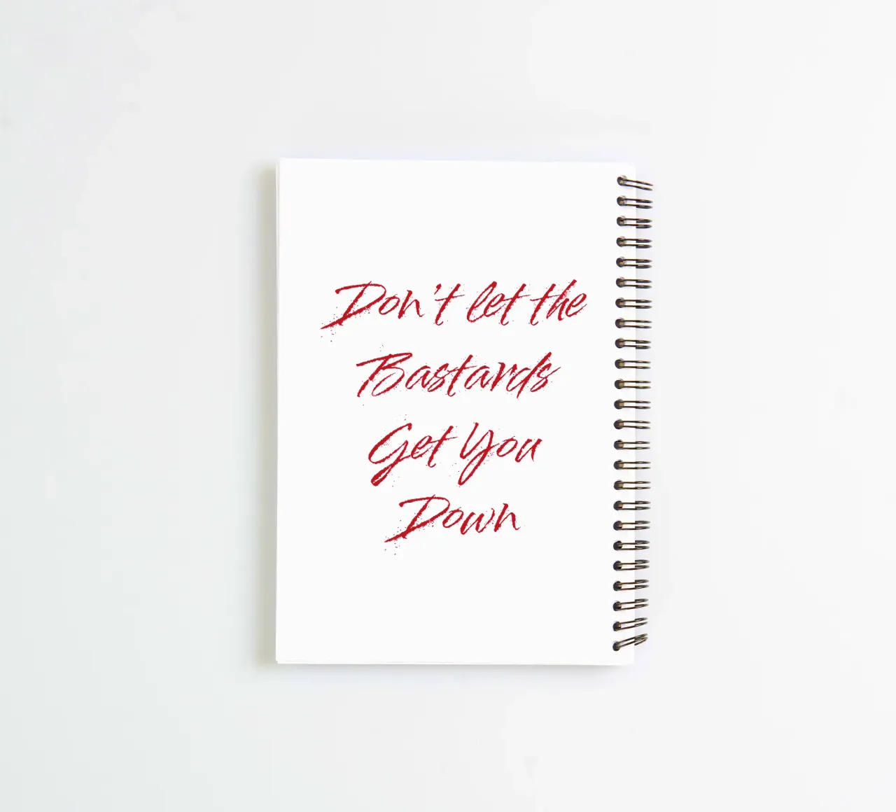'Don't Let The Bastards Get You Down' - Red Text spiral notebook by FABOArt