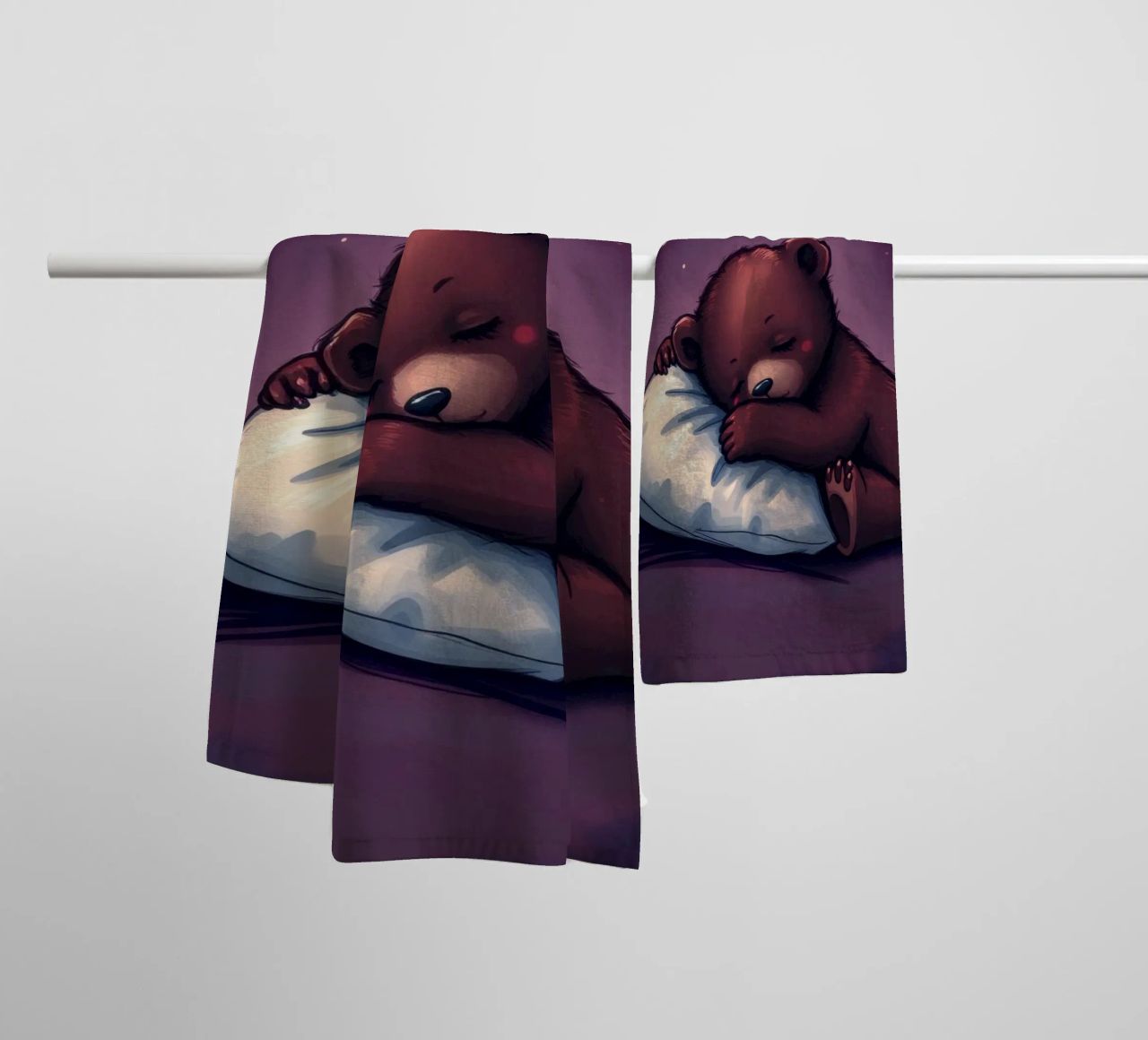 Un mignon ours brun câline un oreiller sous un ciel étoilé serviette de bain de DesignDoodle
