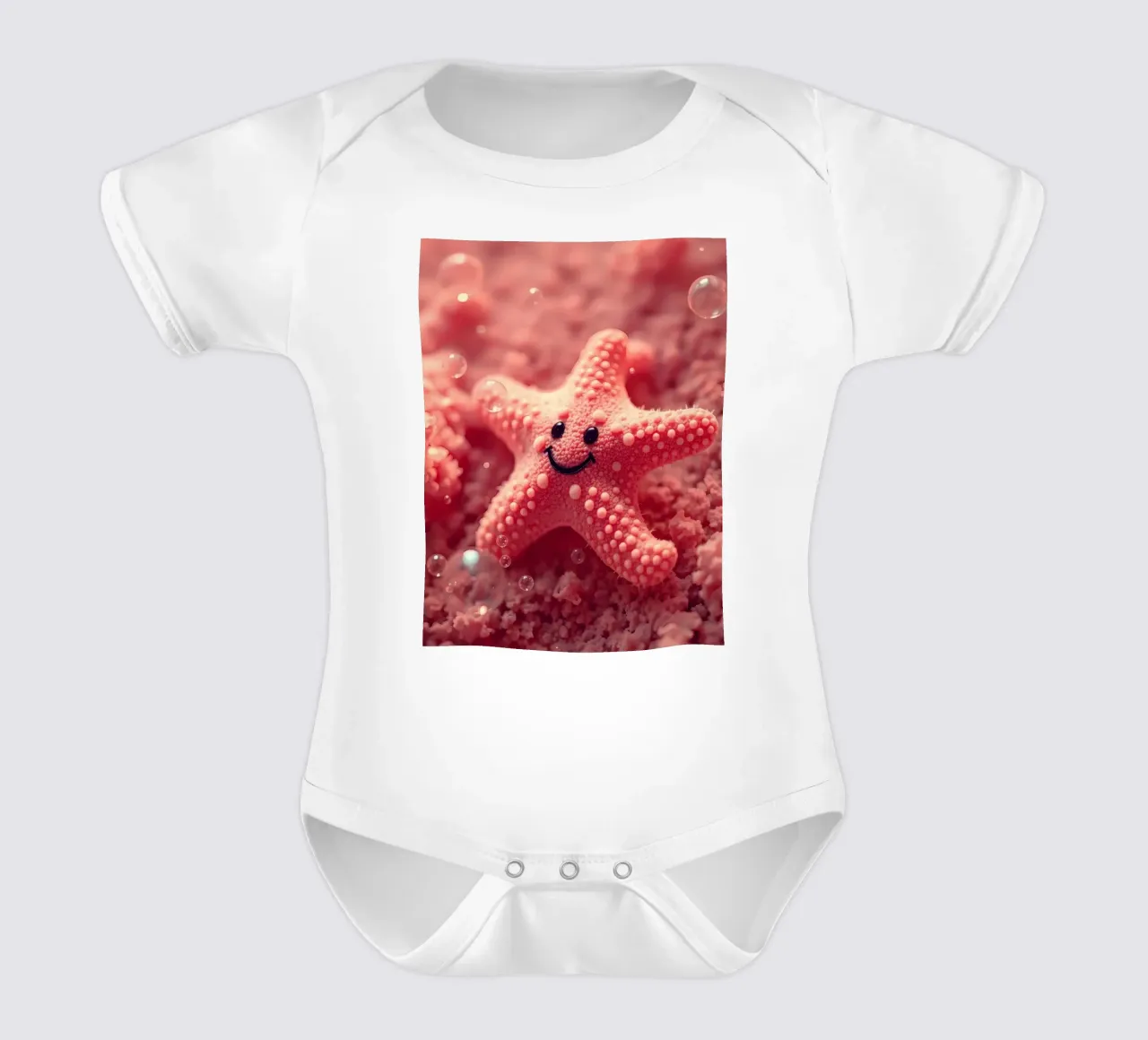 Bright coral starfish with a smiling face resting on pink short-sleeve baby romper by DesignDoodle