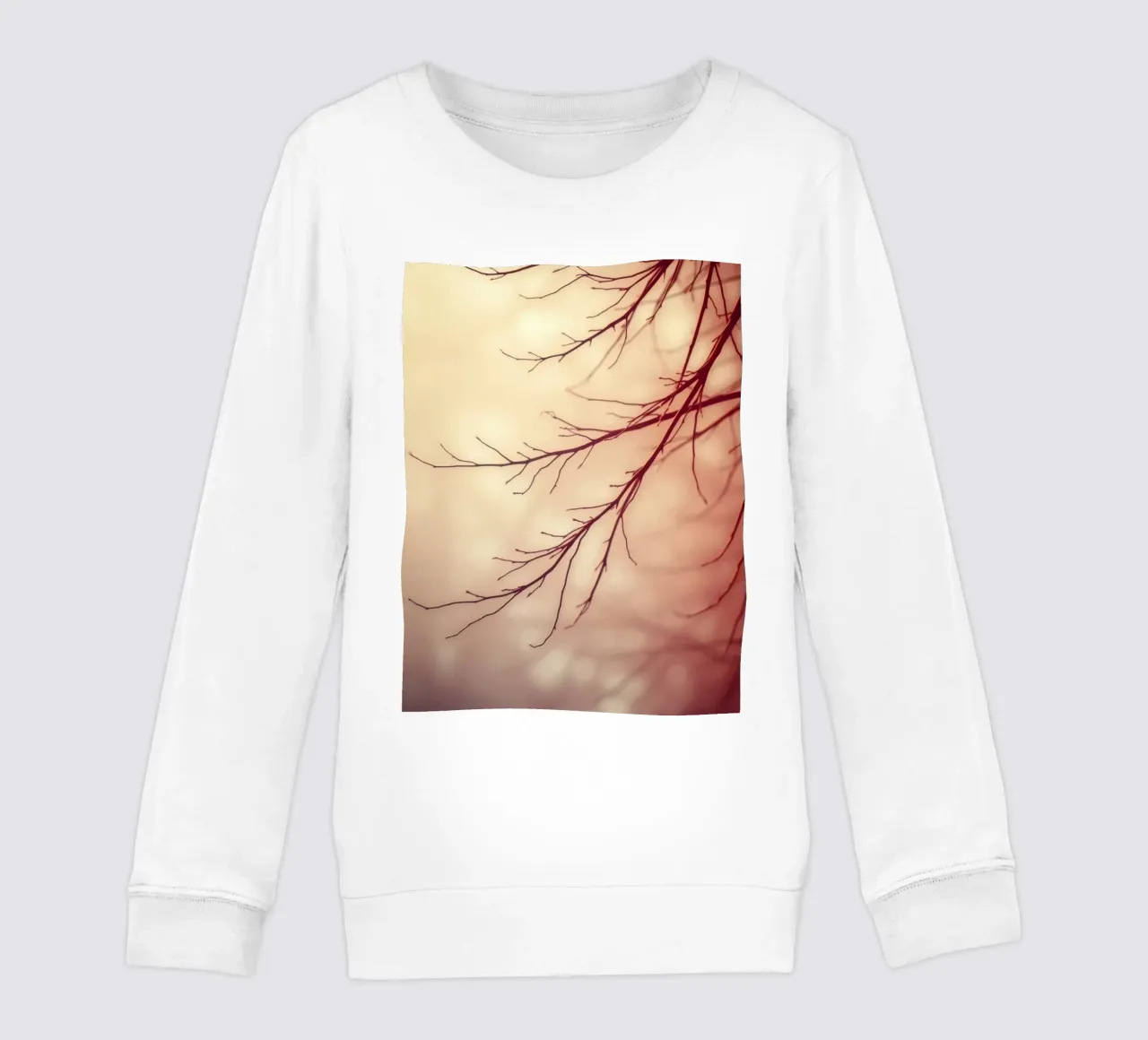 a softly blurred background with graceful tree branches kids sweatshirt by DesignDoodle