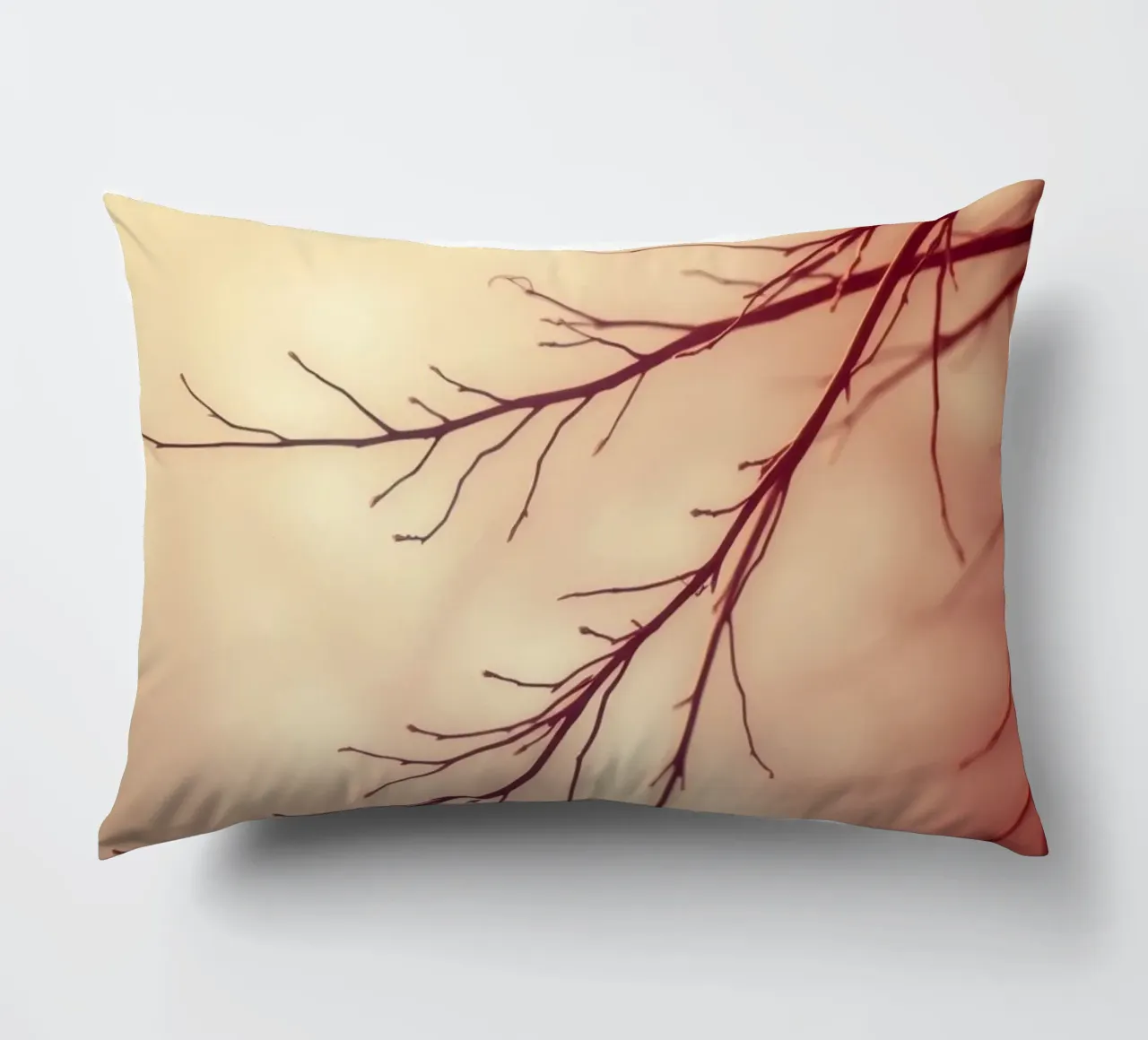 a softly blurred background with graceful tree branches decorative cushion by DesignDoodle