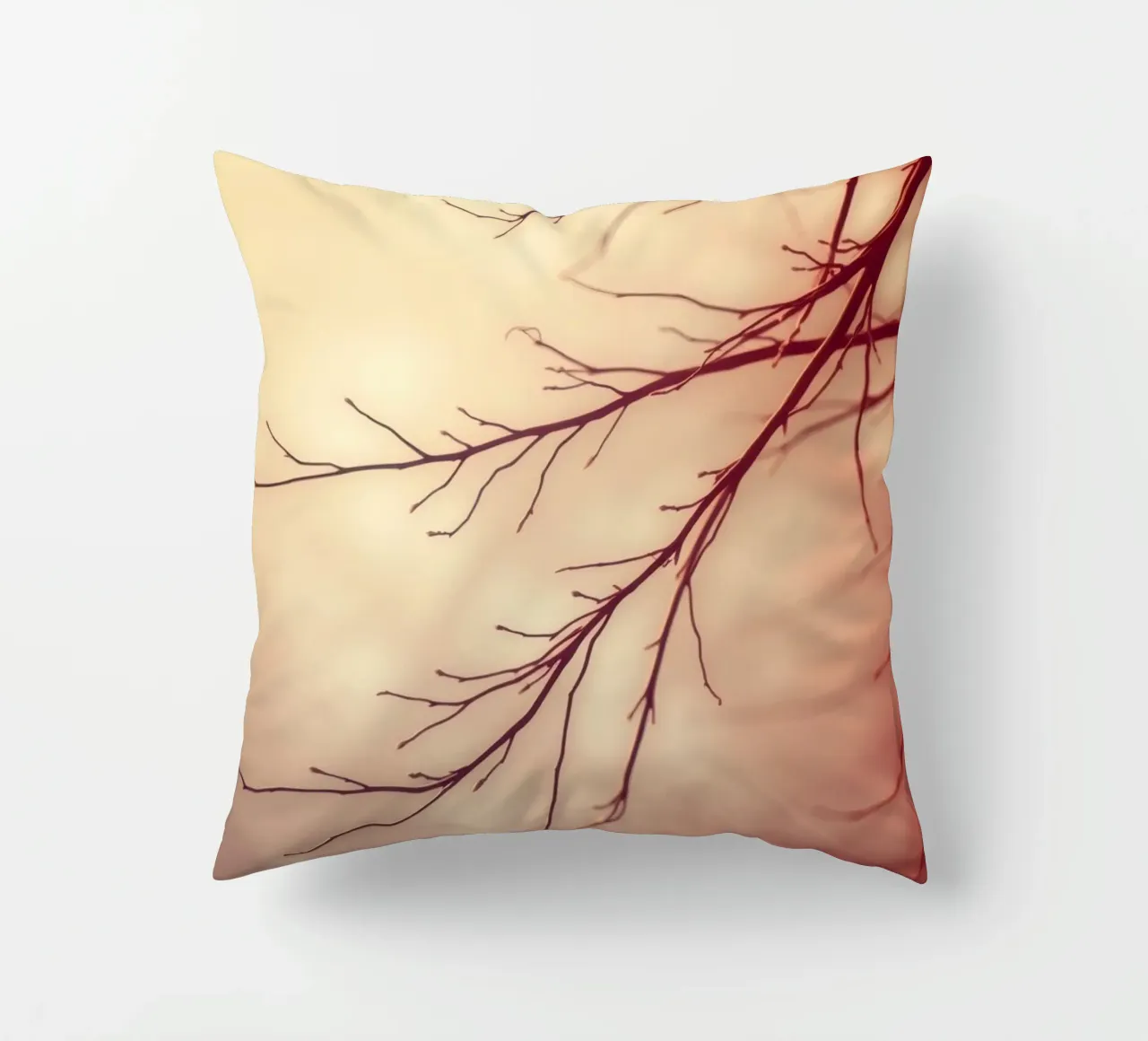 a softly blurred background with graceful tree branches decorative cushion by DesignDoodle