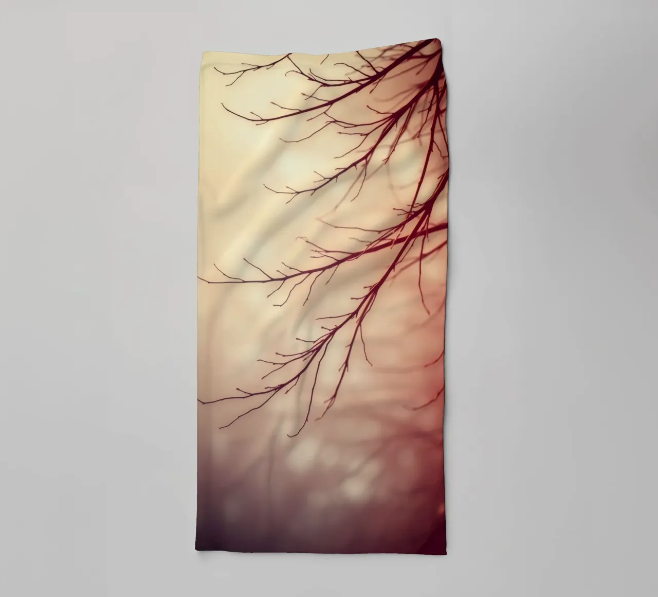 a softly blurred background with graceful tree branches towel by DesignDoodle