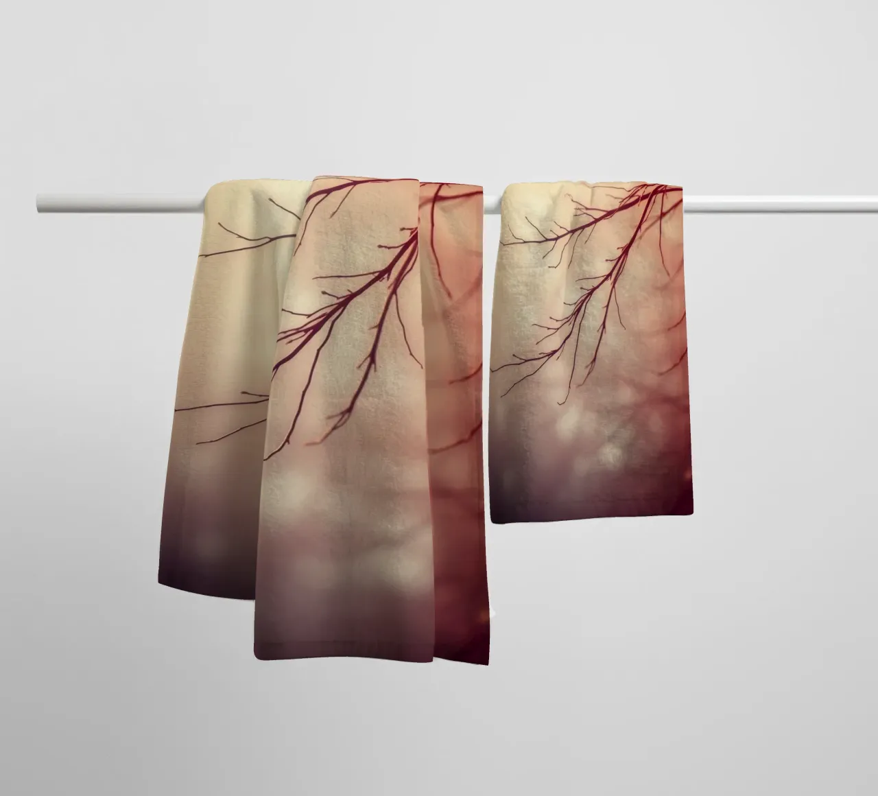 a softly blurred background with graceful tree branches towel by DesignDoodle