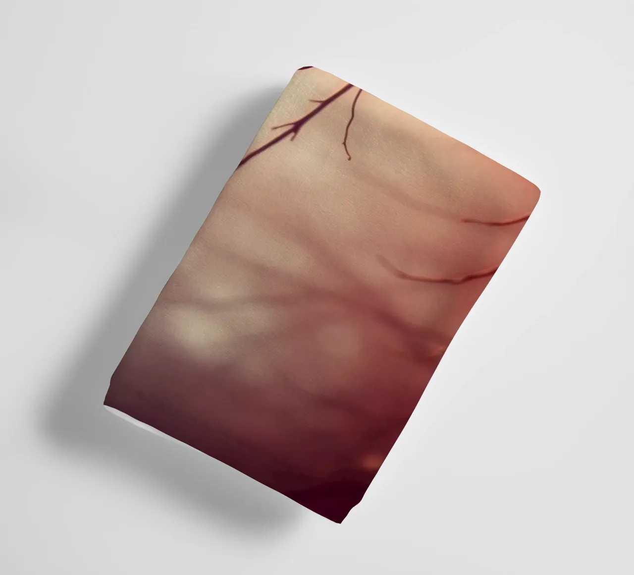 a softly blurred background with graceful tree branches towel by DesignDoodle