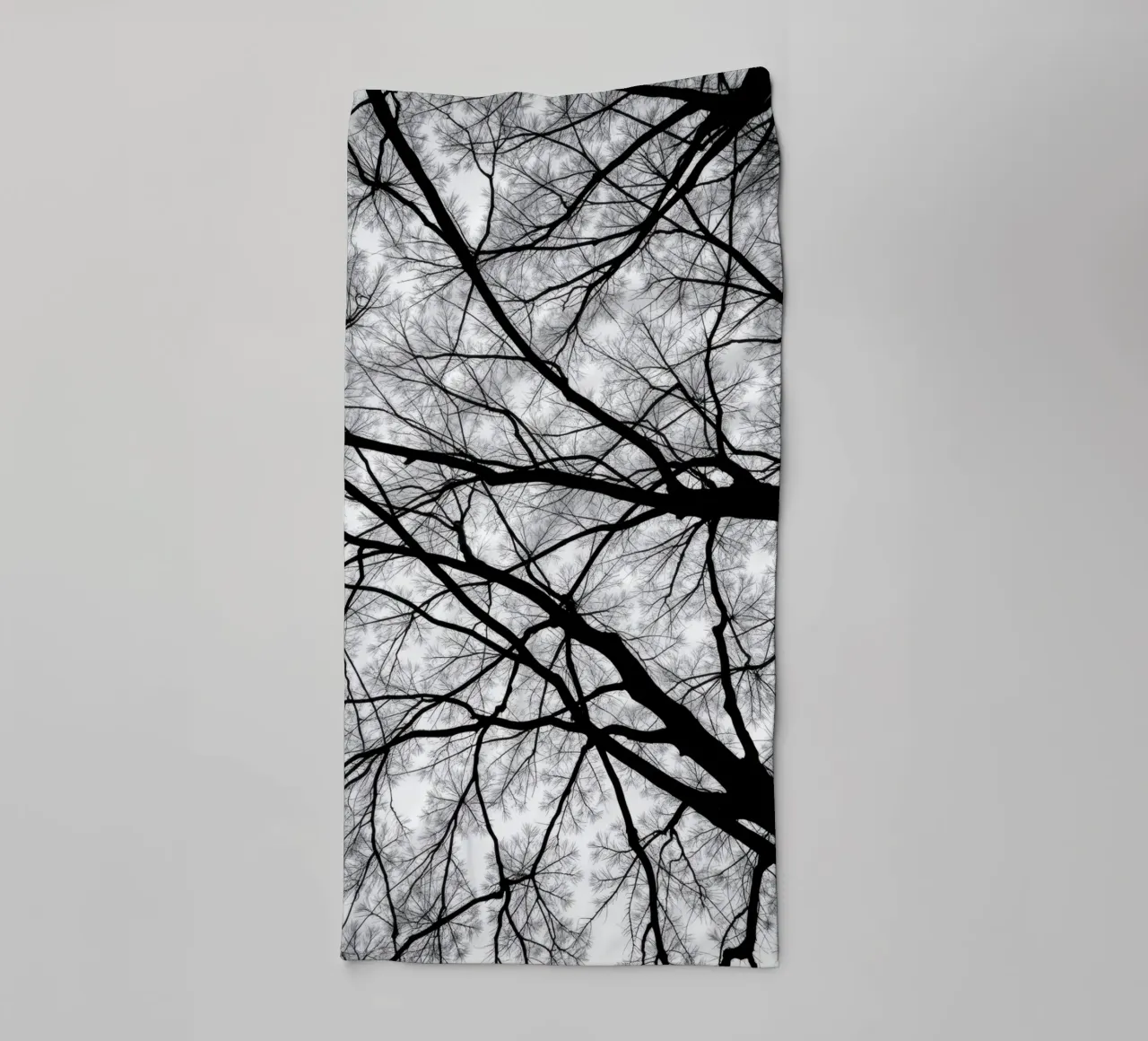 Lifeless branches stretch against a cloudy sky towel by DesignDoodle