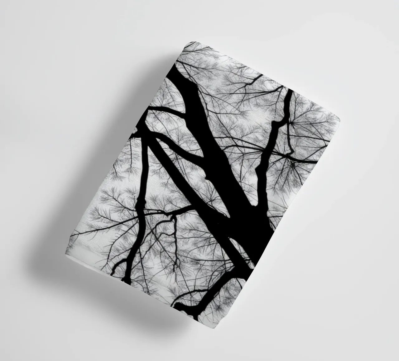 Lifeless branches stretch against a cloudy sky towel by DesignDoodle