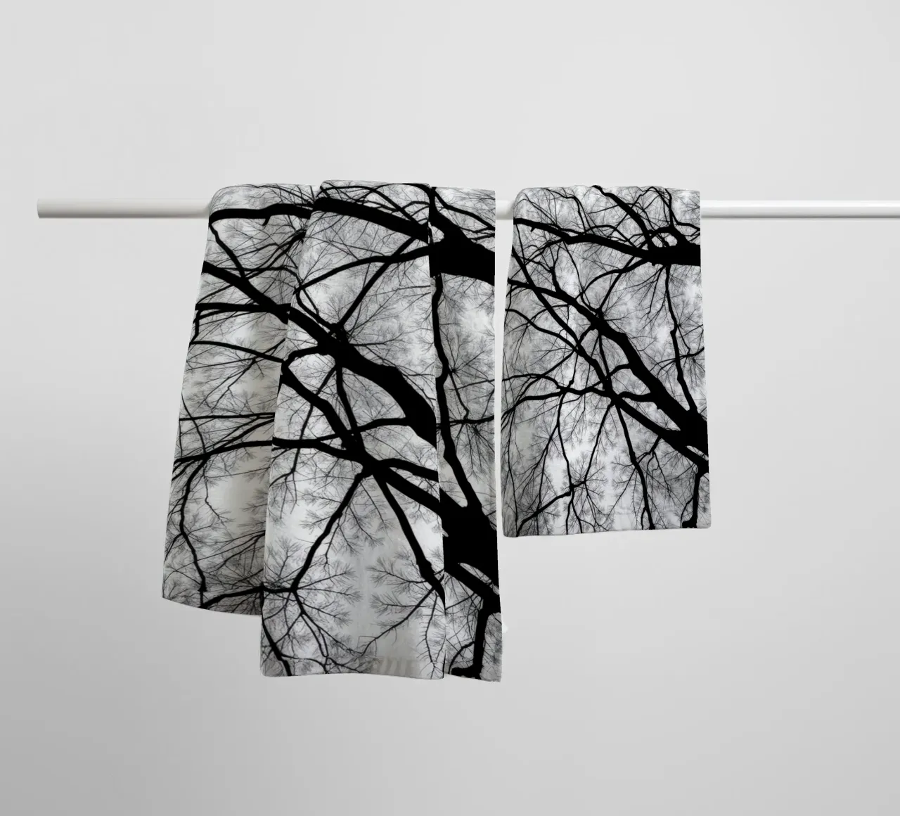 Lifeless branches stretch against a cloudy sky towel by DesignDoodle
