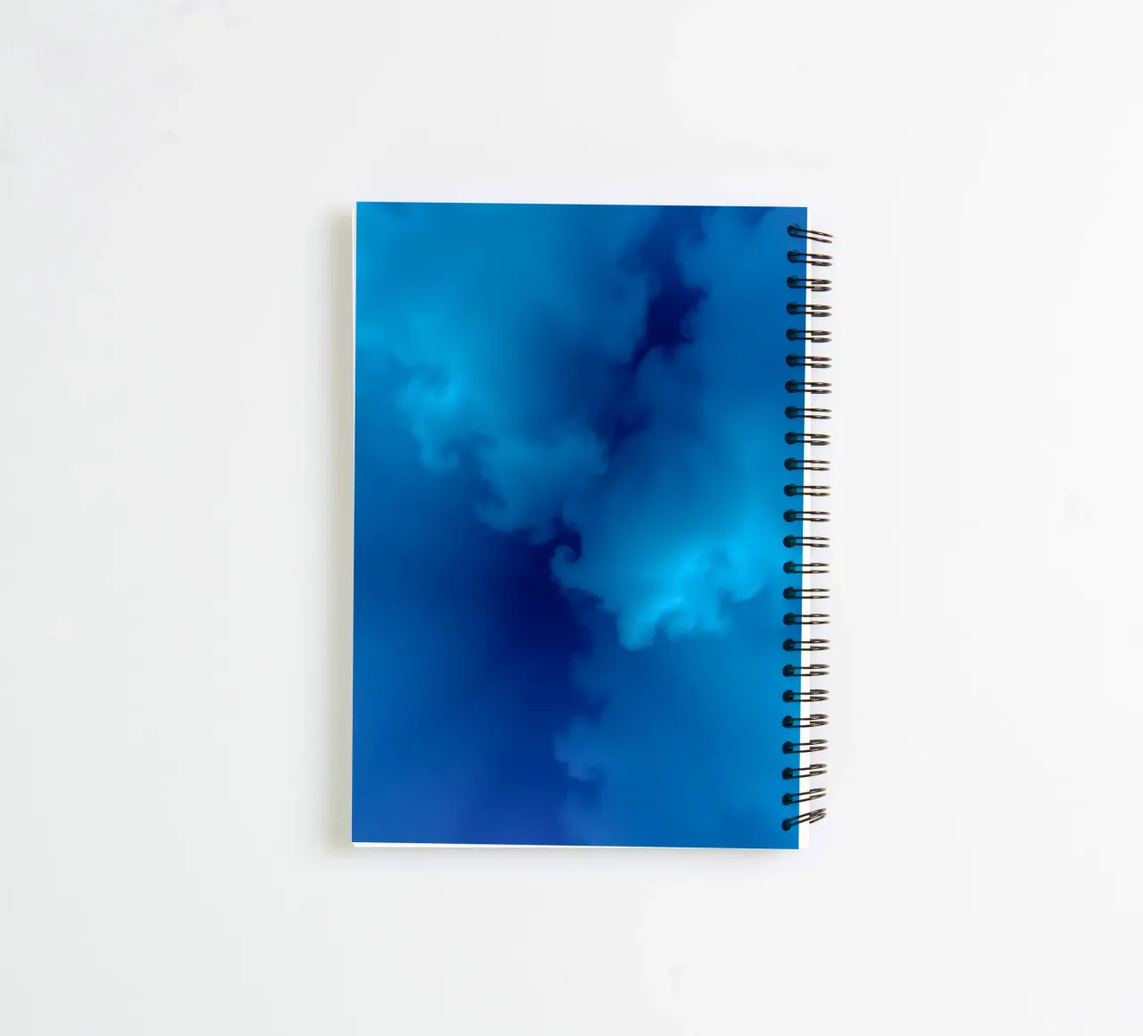 Soft blue abstract wallpaper creating a serene and calming spiral notebook by DesignDoodle