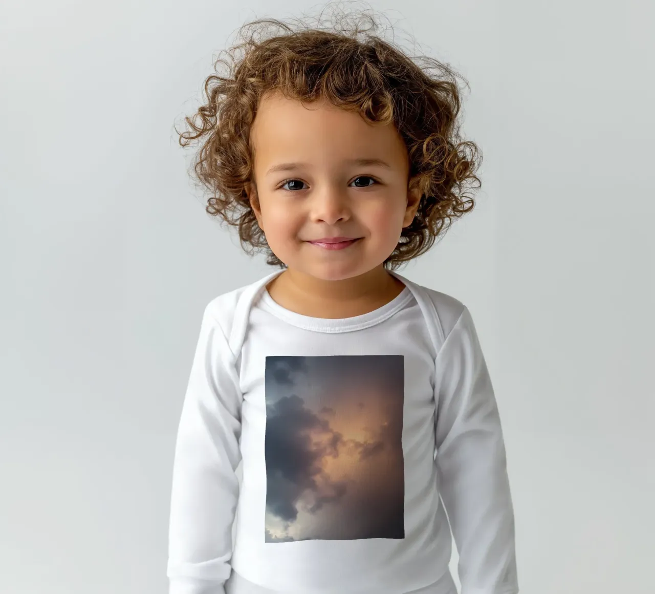 Soft hues of twilight emerge through clouds long-sleeve baby romper by DesignDoodle