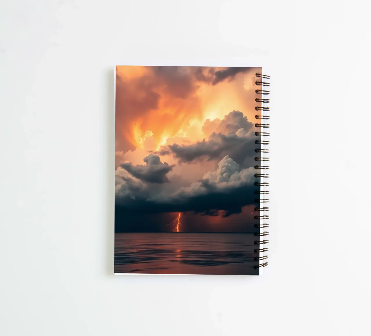 Dramatic sunset with storm clouds and lightning illuminating spiral notebook by DesignDoodle