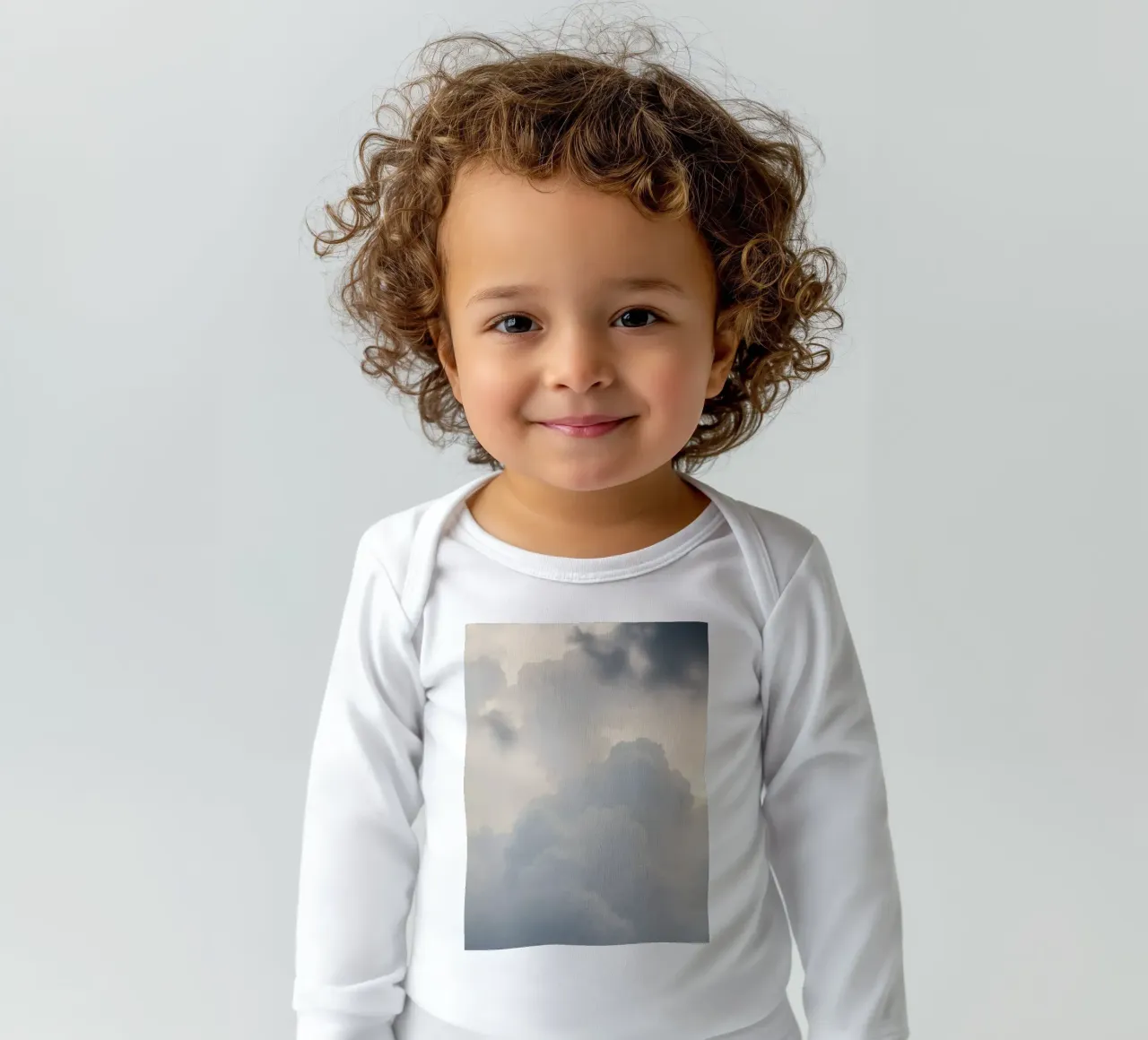 Sky filled with soft clouds and light hues a calm and sooth long-sleeve baby romper by DesignDoodle