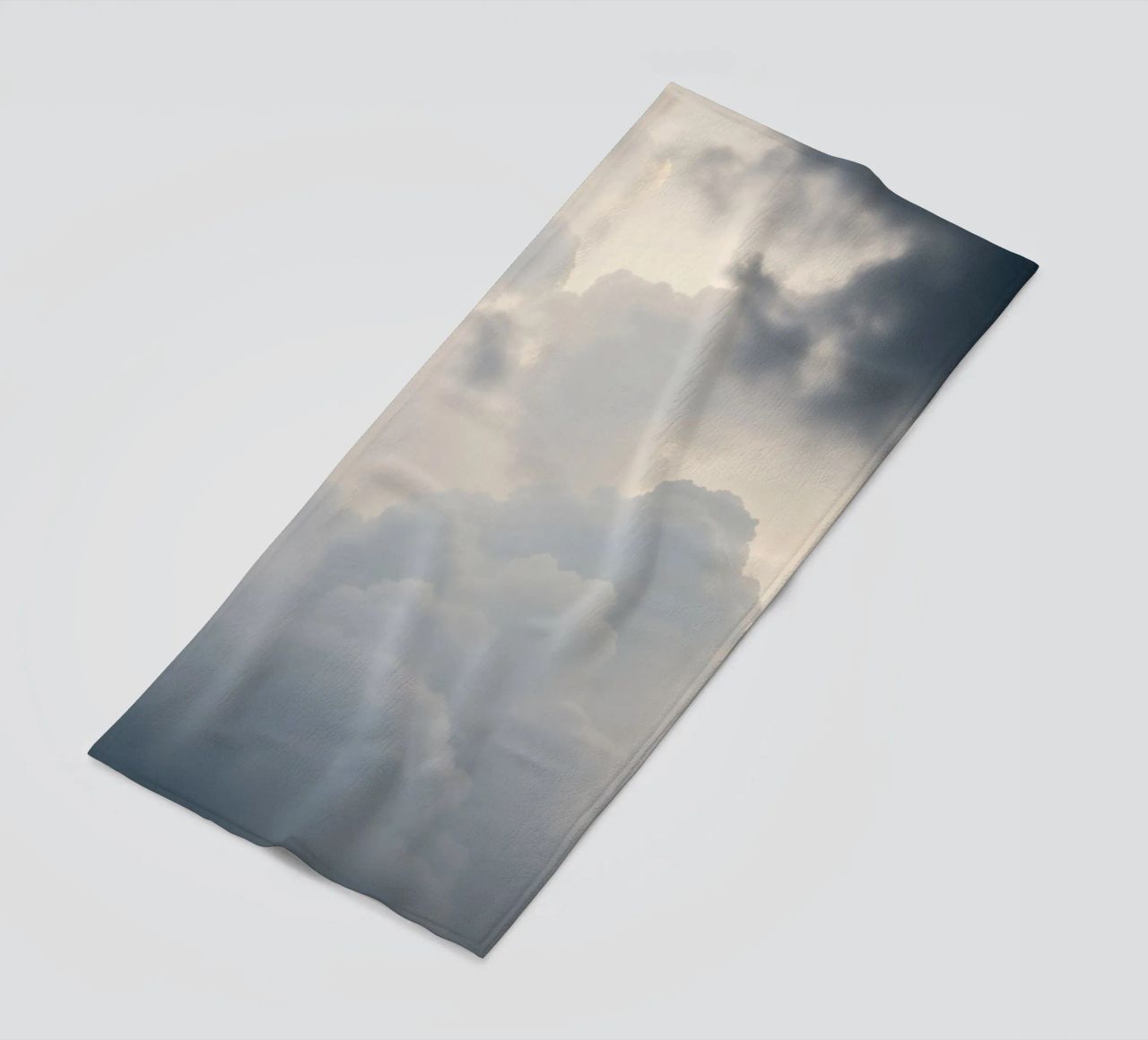 Sky filled with soft clouds and light hues a calm and sooth beach towel by DesignDoodle