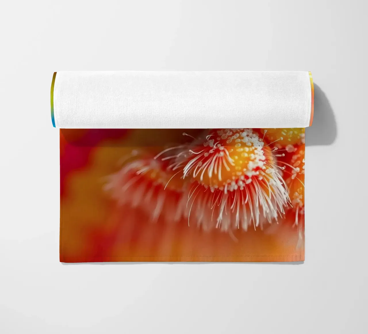 close-up of an abstract creature featuring colorful patterns beach towel by DesignDoodle