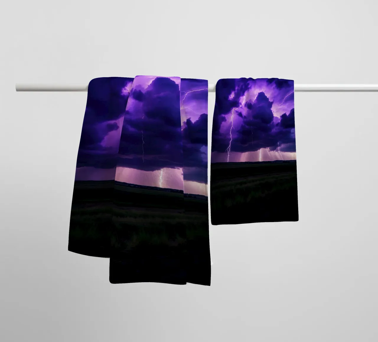 lightning storms illuminate dark purple clouds towel by DesignDoodle