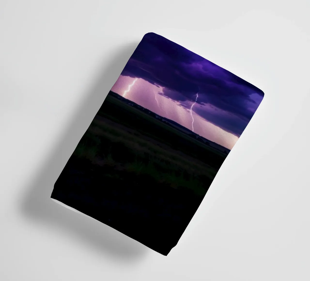 lightning storms illuminate dark purple clouds towel by DesignDoodle