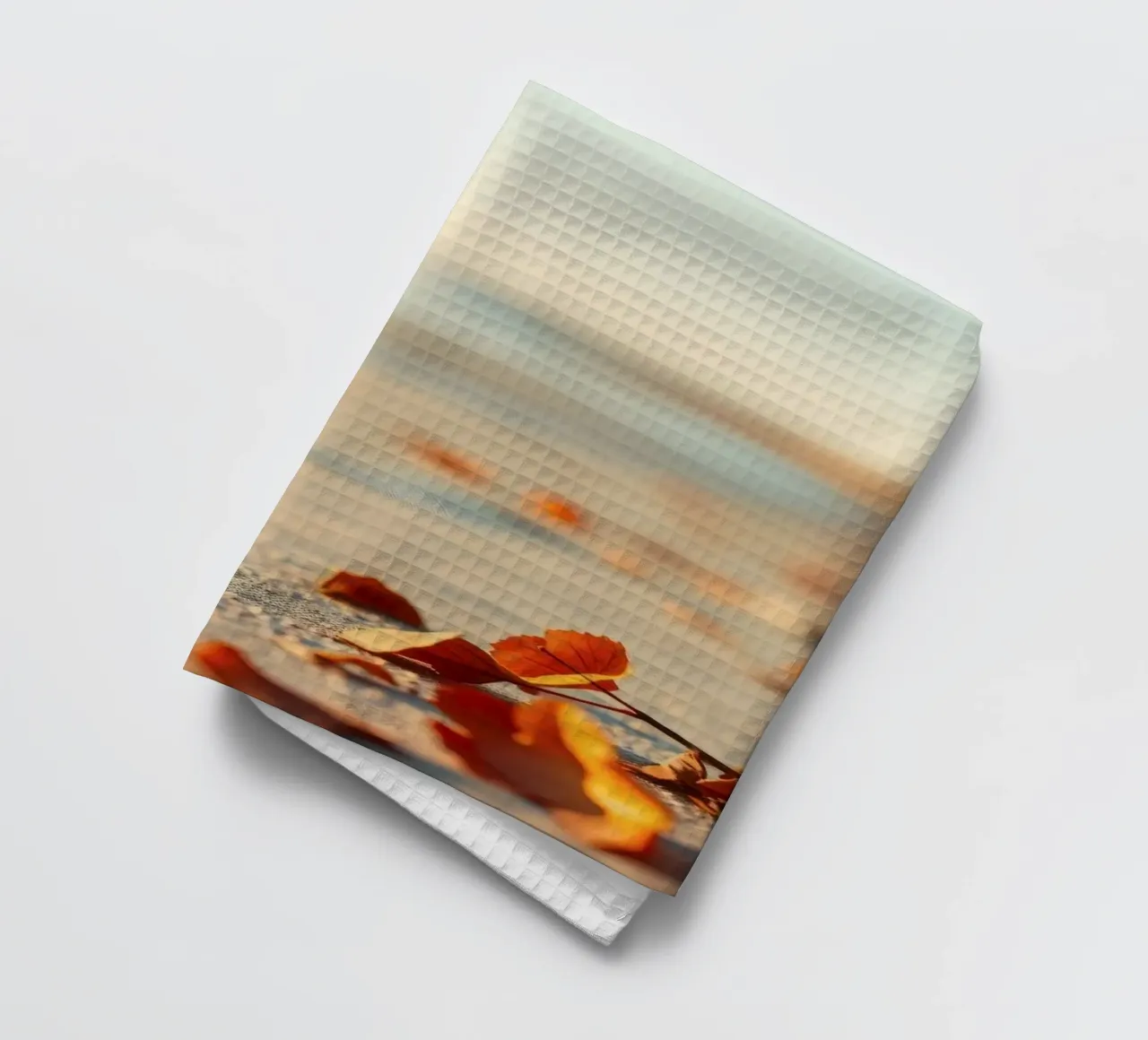 Foglie d'autunno sparse sulla spiaggia sabbiosa al tramonto canovaccio da cucina da DesignDoodle