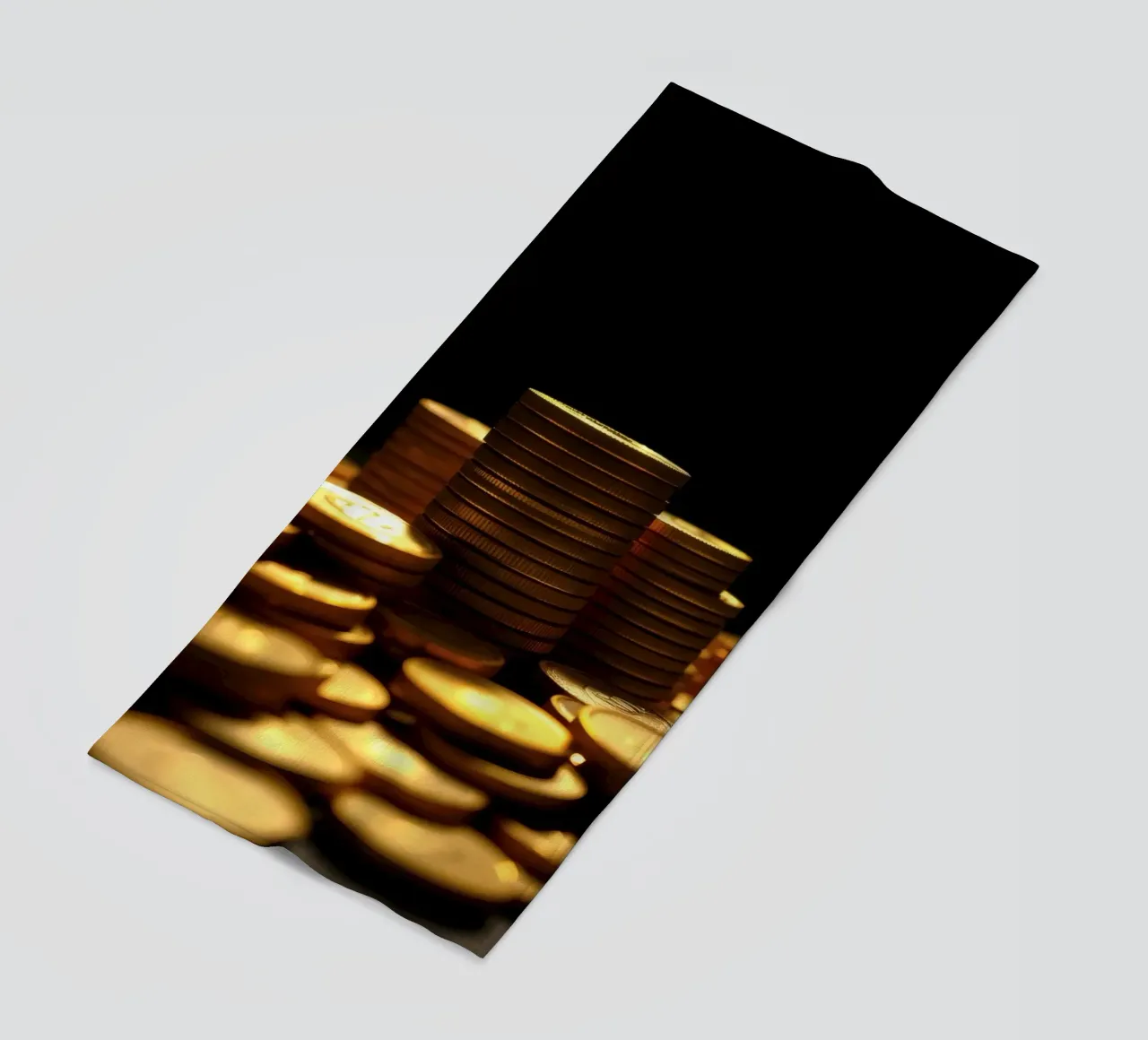 Stacks of shiny coins create a dramatic display beach towel by DesignDoodle