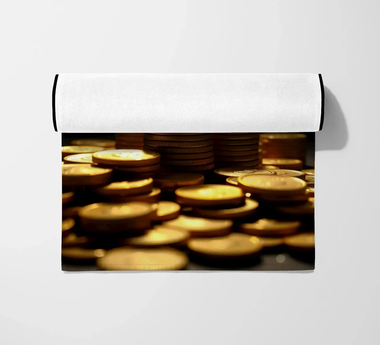 Stacks of shiny coins create a dramatic display beach towel by DesignDoodle