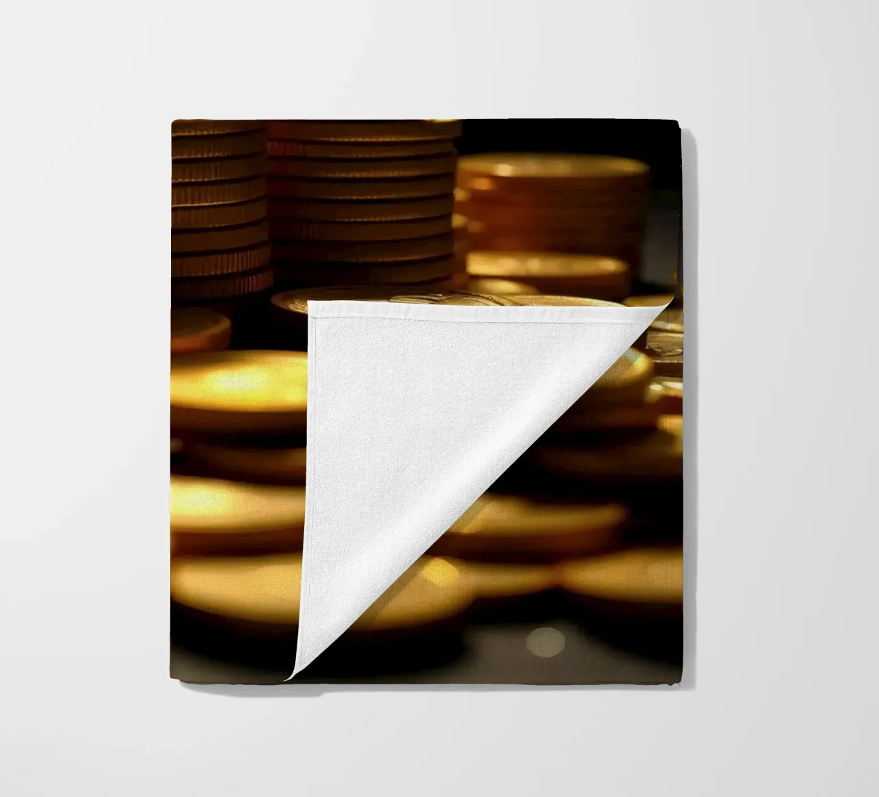 Stacks of shiny coins create a dramatic display beach towel by DesignDoodle