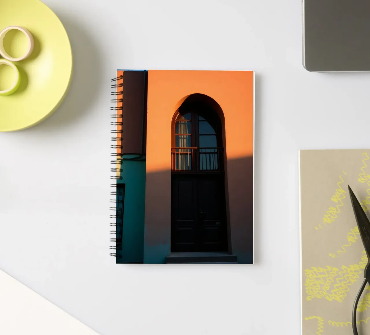 Bright evening sunlight casts shadows on a colorful building spiral notebook by DesignDoodle