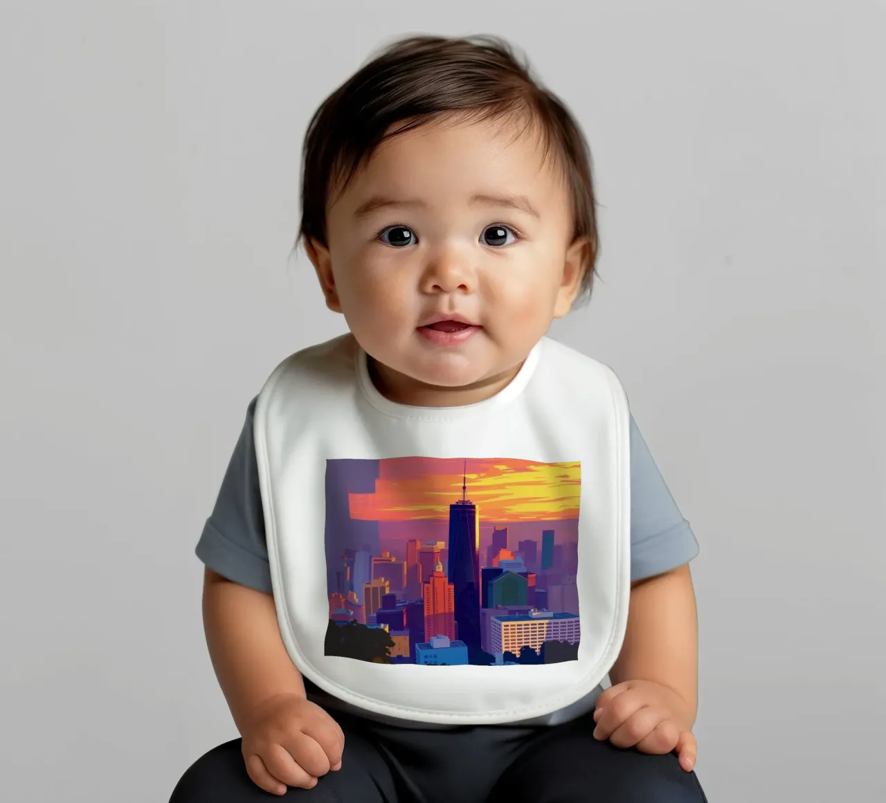 city skyline at sunset showcasing tall buildings baby bib by DesignDoodle