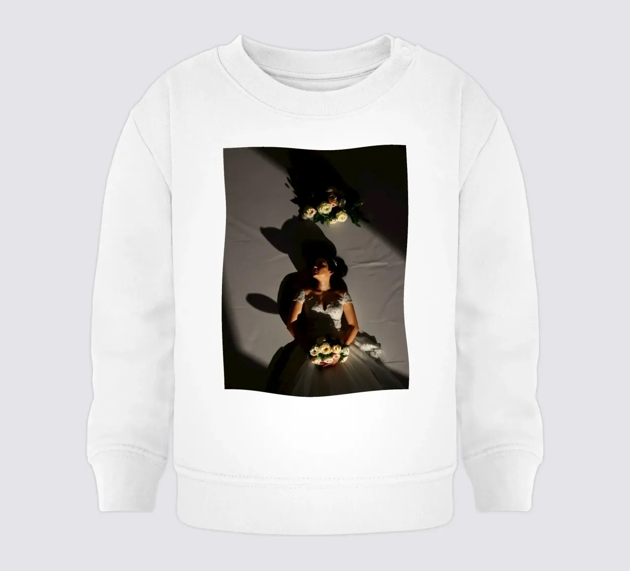 Bride in elegant gown poses dramatically under soft lighting baby sweatshirt by DesignDoodle