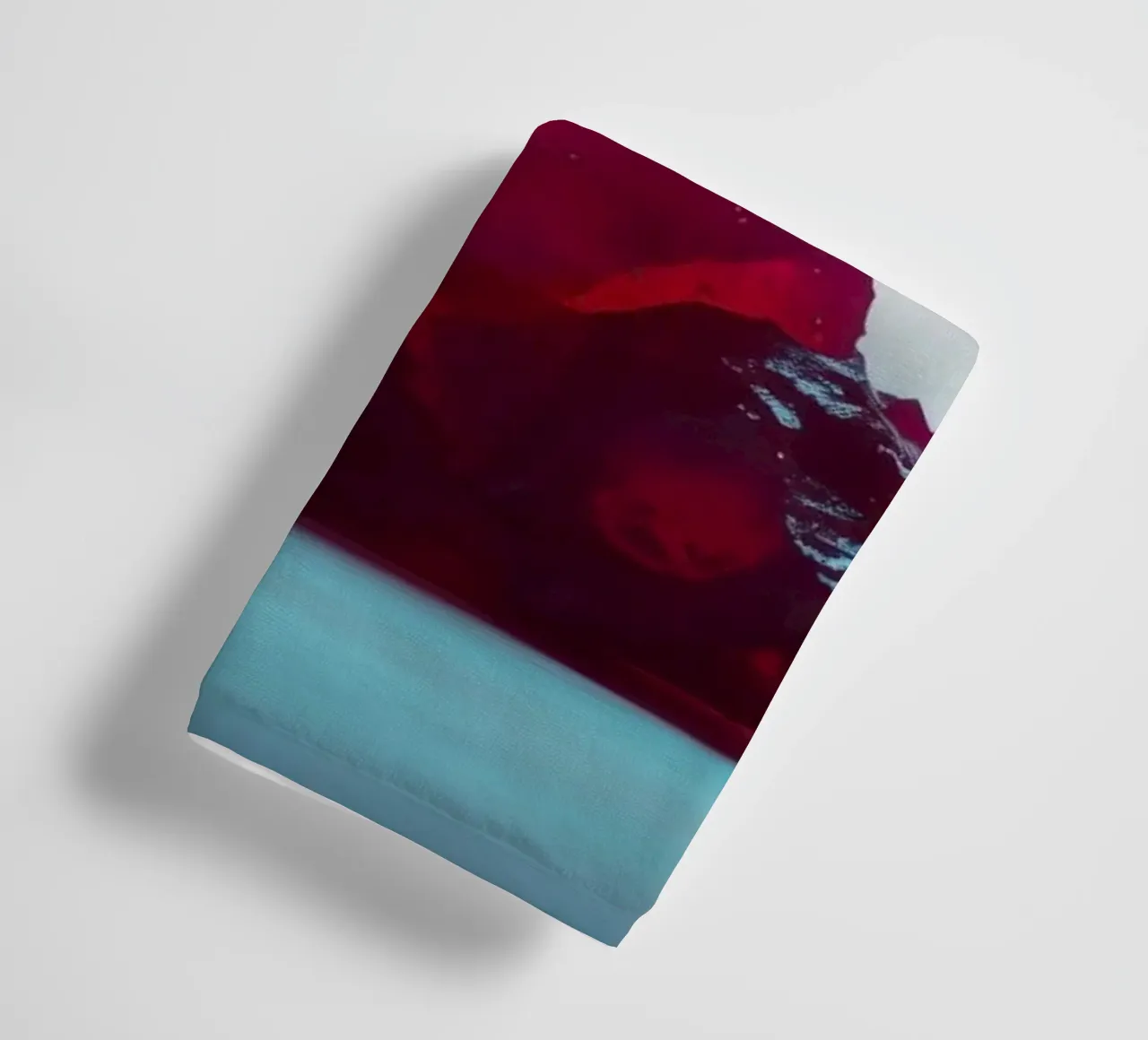 Bright red gelatin cubes scattered on a soft surface towel by DesignDoodle