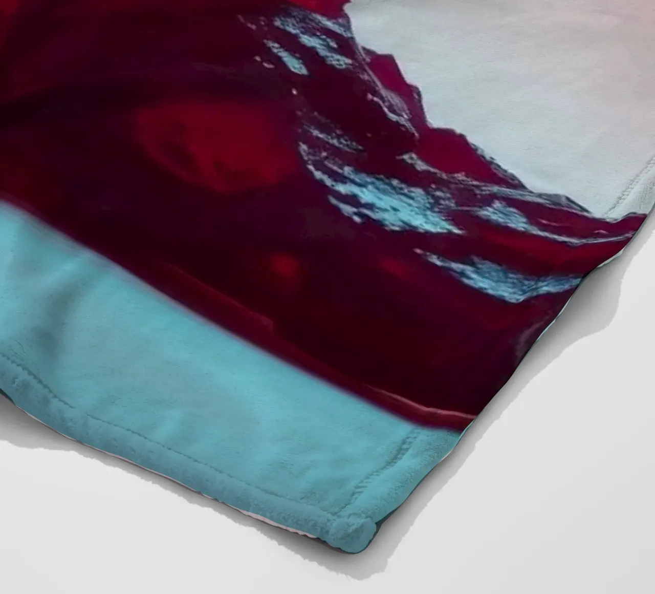 Bright red gelatin cubes scattered on a soft surface fleece blanket by DesignDoodle
