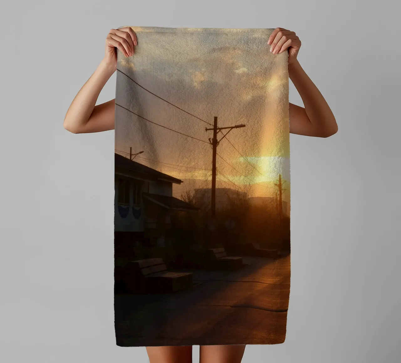 Sunset casts a golden glow over a quiet street lined towel by DesignDoodle