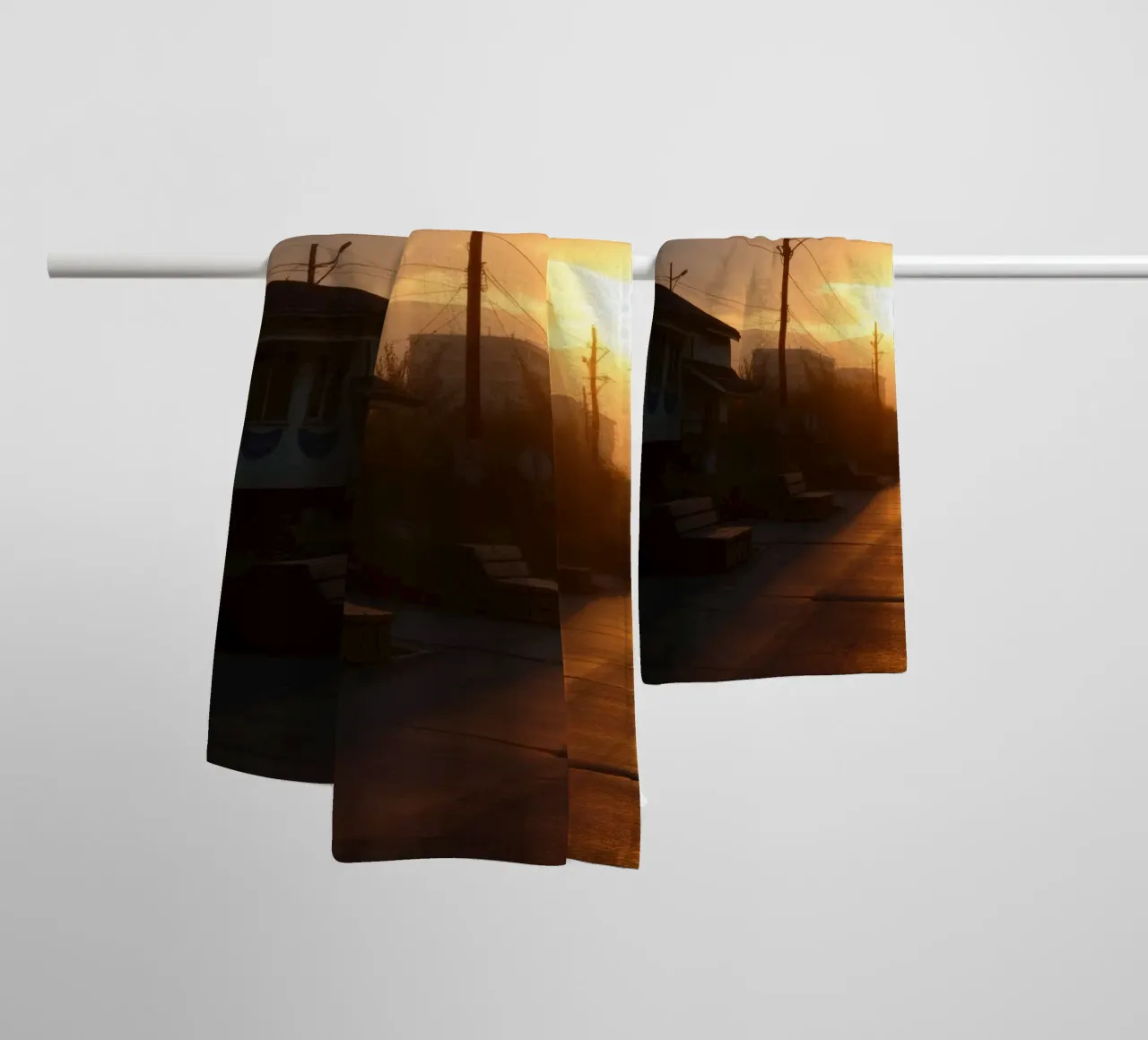 Sunset casts a golden glow over a quiet street lined towel by DesignDoodle