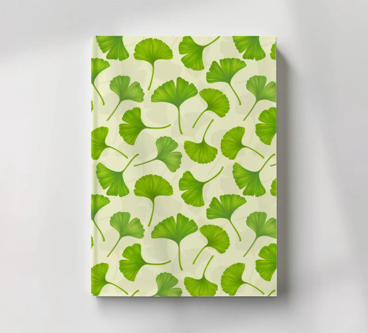 Ginkgo leaves on off white notebook by Painted Nature