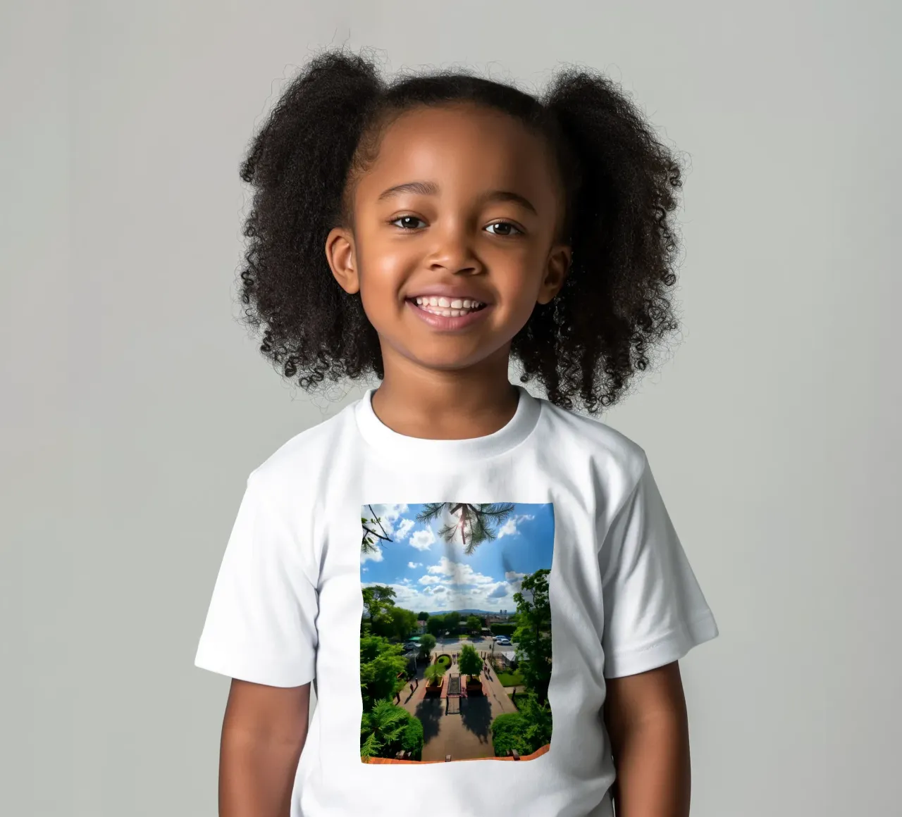a sunny day in a green park with pathways and a city skyline kids t-shirt by DesignDoodle