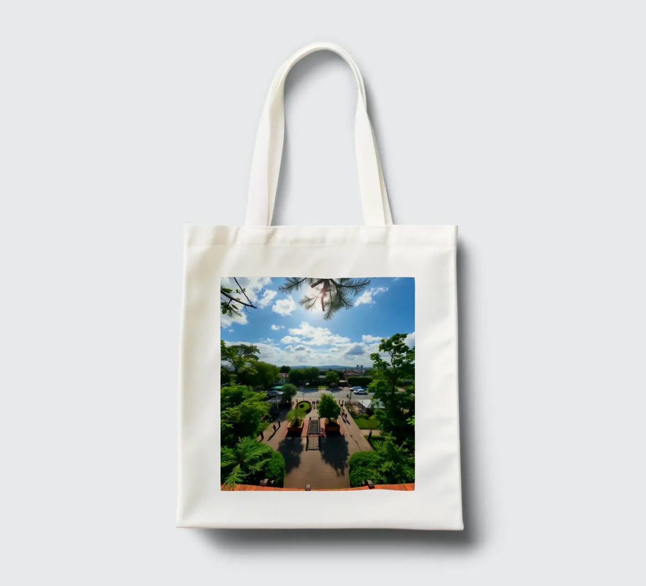a sunny day in a green park with pathways and a city skyline tote bag by DesignDoodle