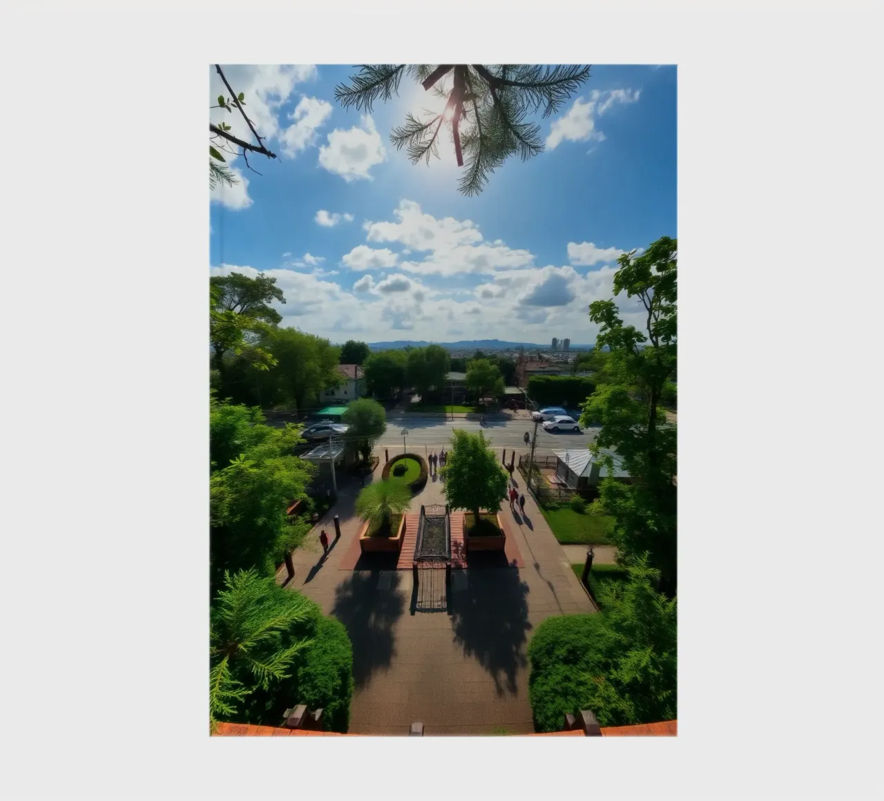 a sunny day in a green park with pathways and a city skyline notebook by DesignDoodle