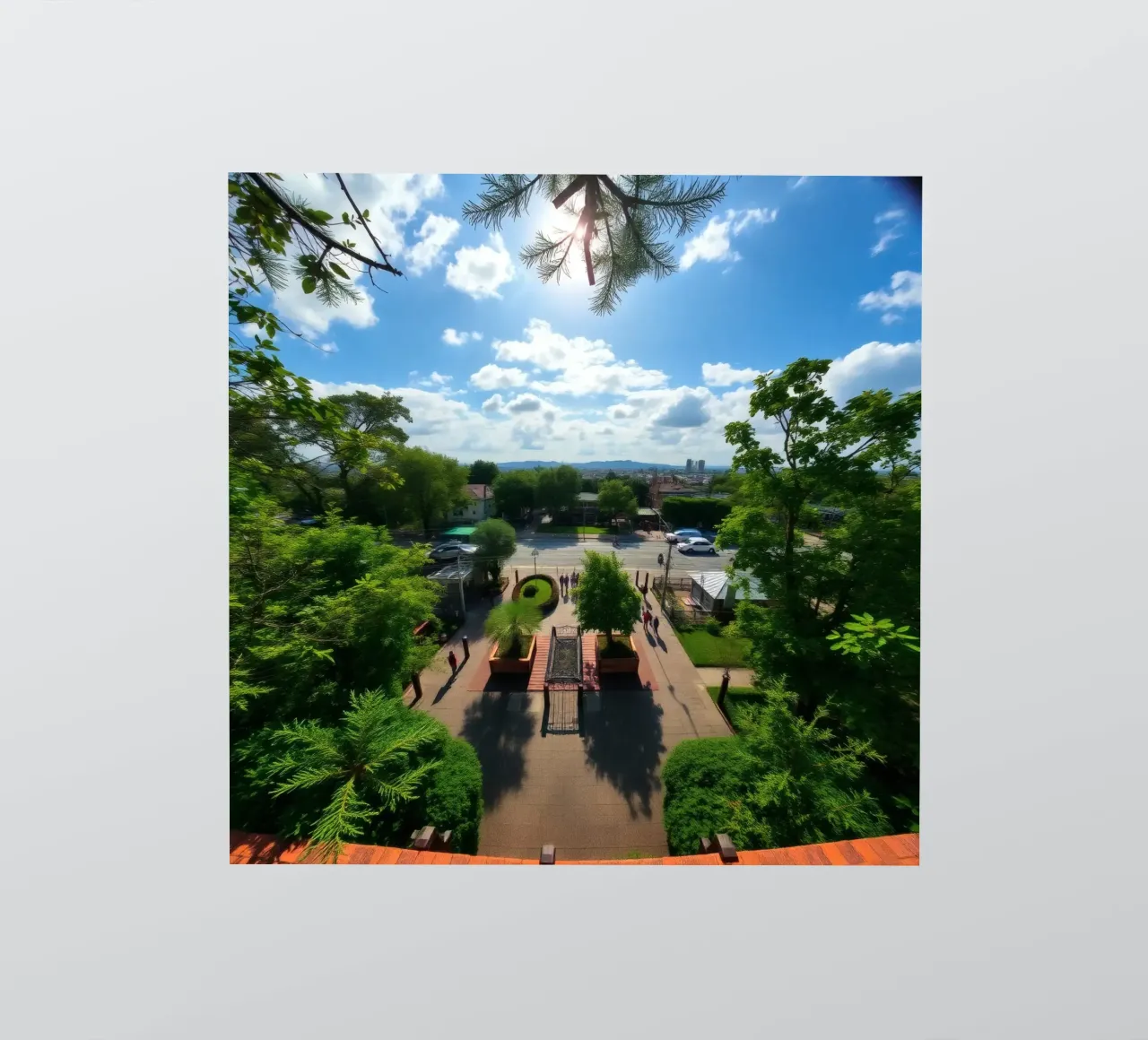 une journée ensoleillée dans un parc verdoyant avec des allées et l'horizon d'une ville autocollant de DesignDoodle