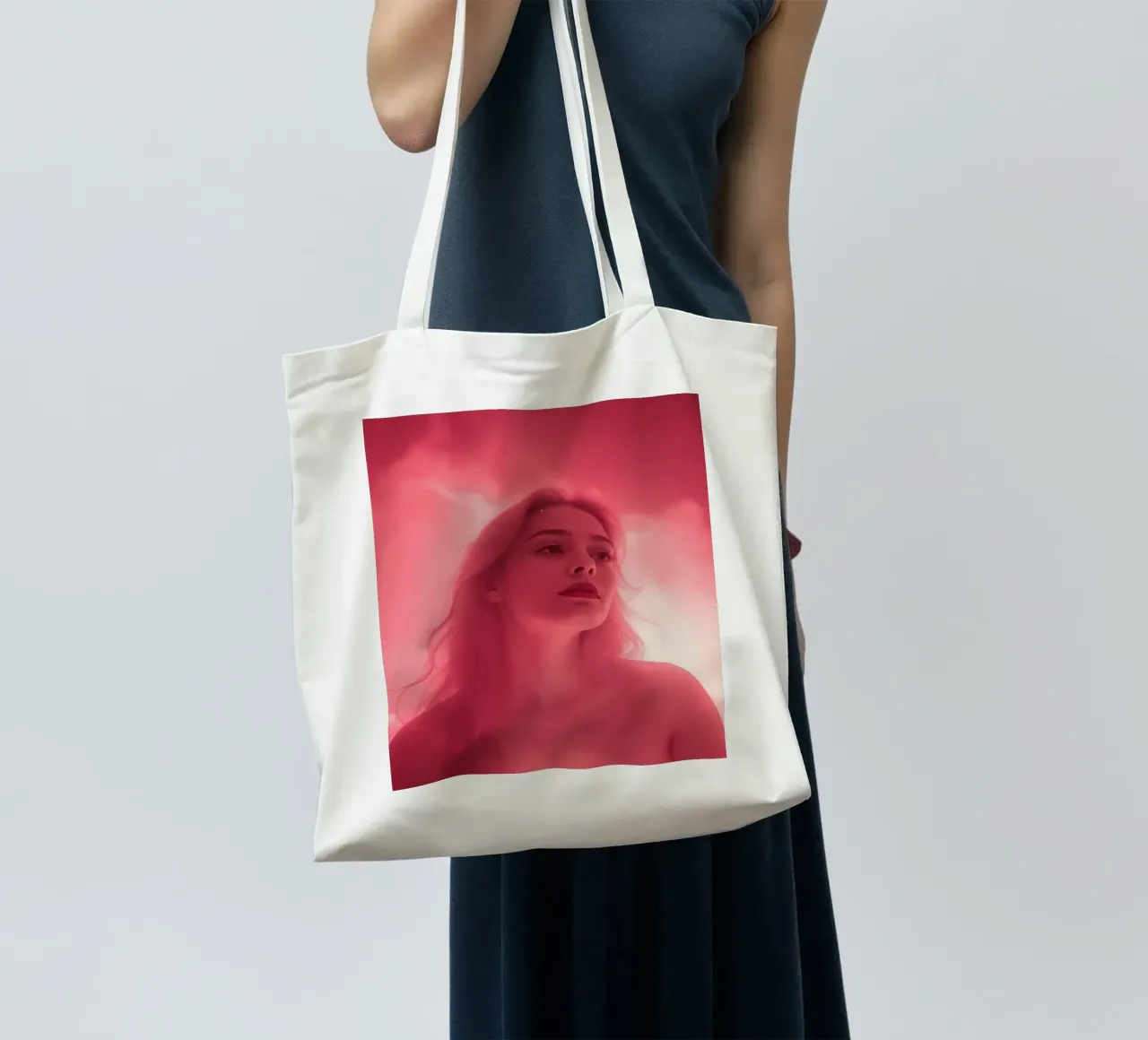 Soft pink light envelops a woman with long hair tote bag by DesignDoodle