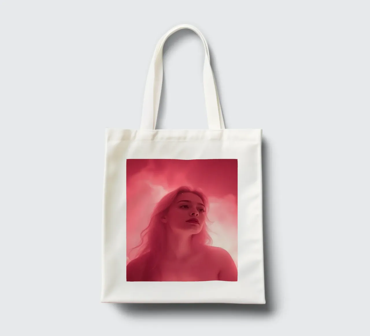 Soft pink light envelops a woman with long hair tote bag by DesignDoodle