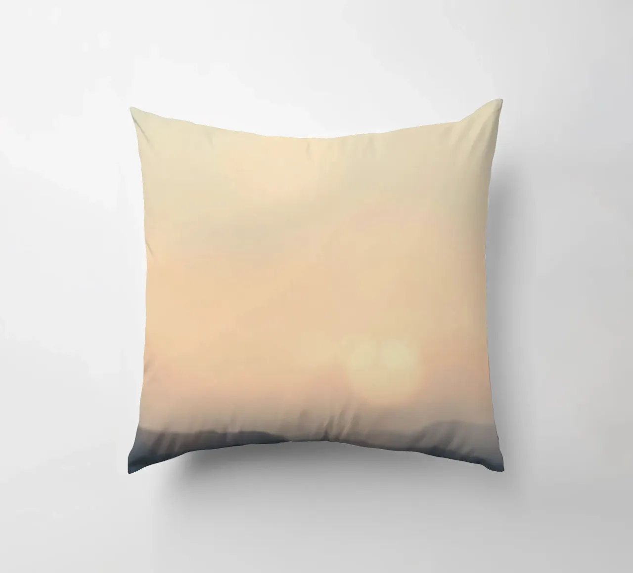 Sunset casting a warm glow over distant mountains and cloude decorative cushion by DesignDoodle