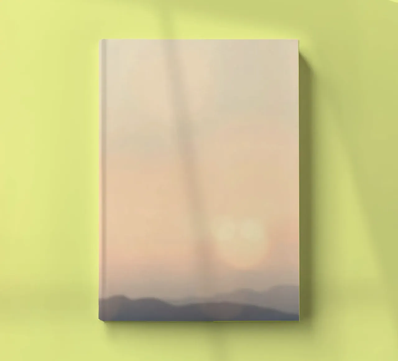 Sunset casting a warm glow over distant mountains and cloude notebook by DesignDoodle