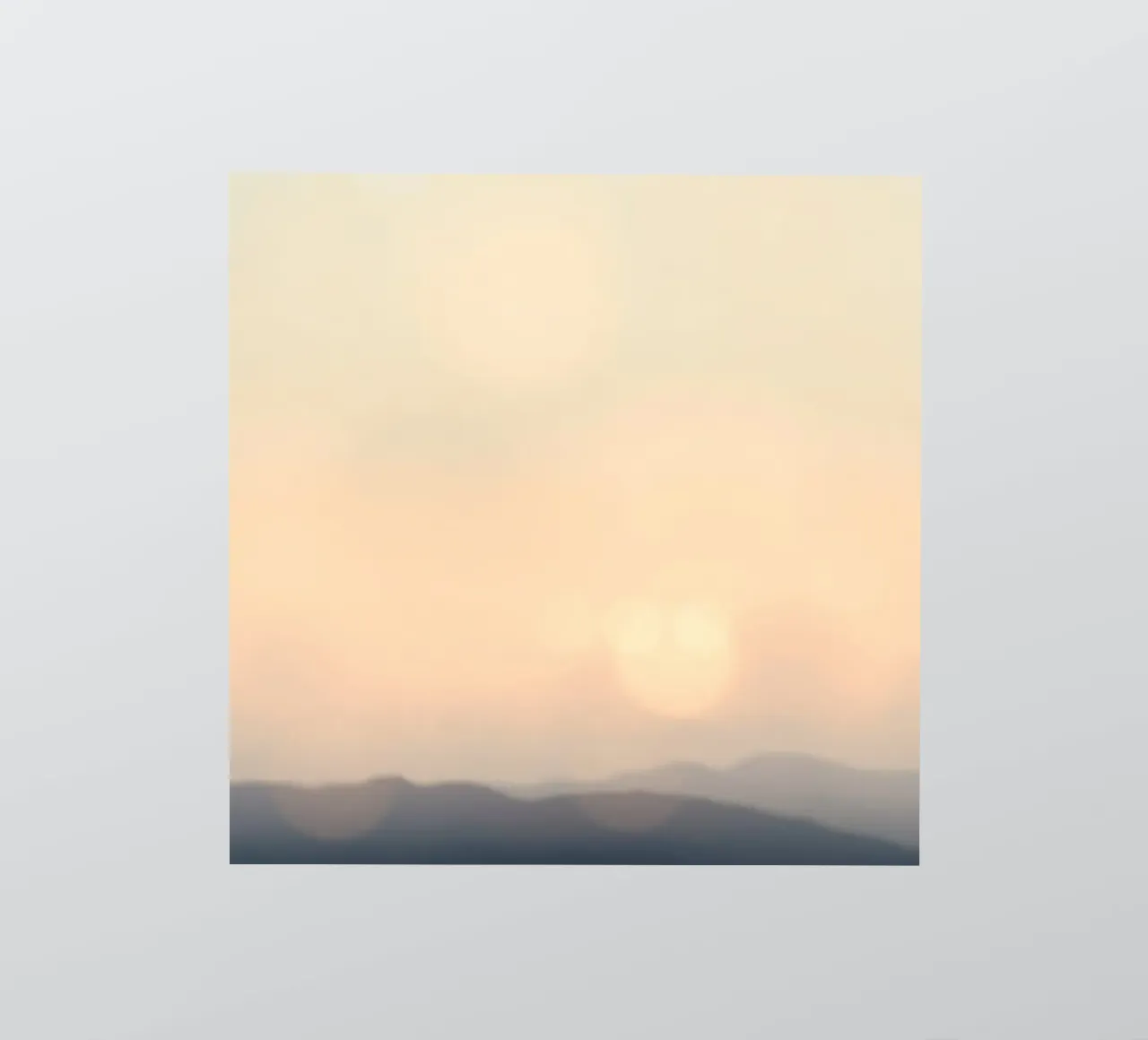 Sunset casting a warm glow over distant mountains and cloude sticker by DesignDoodle