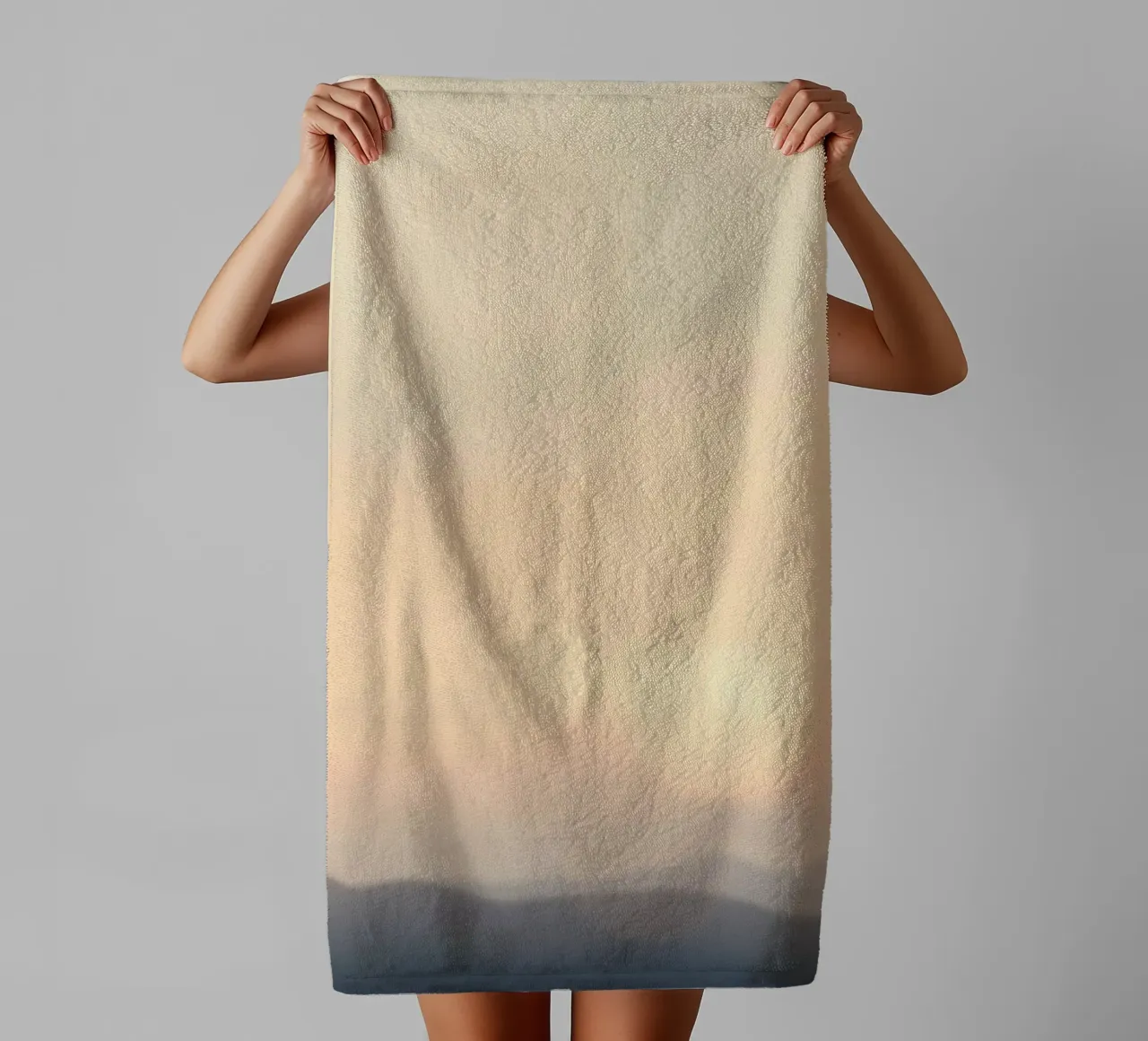 Sunset casting a warm glow over distant mountains and cloude towel by DesignDoodle