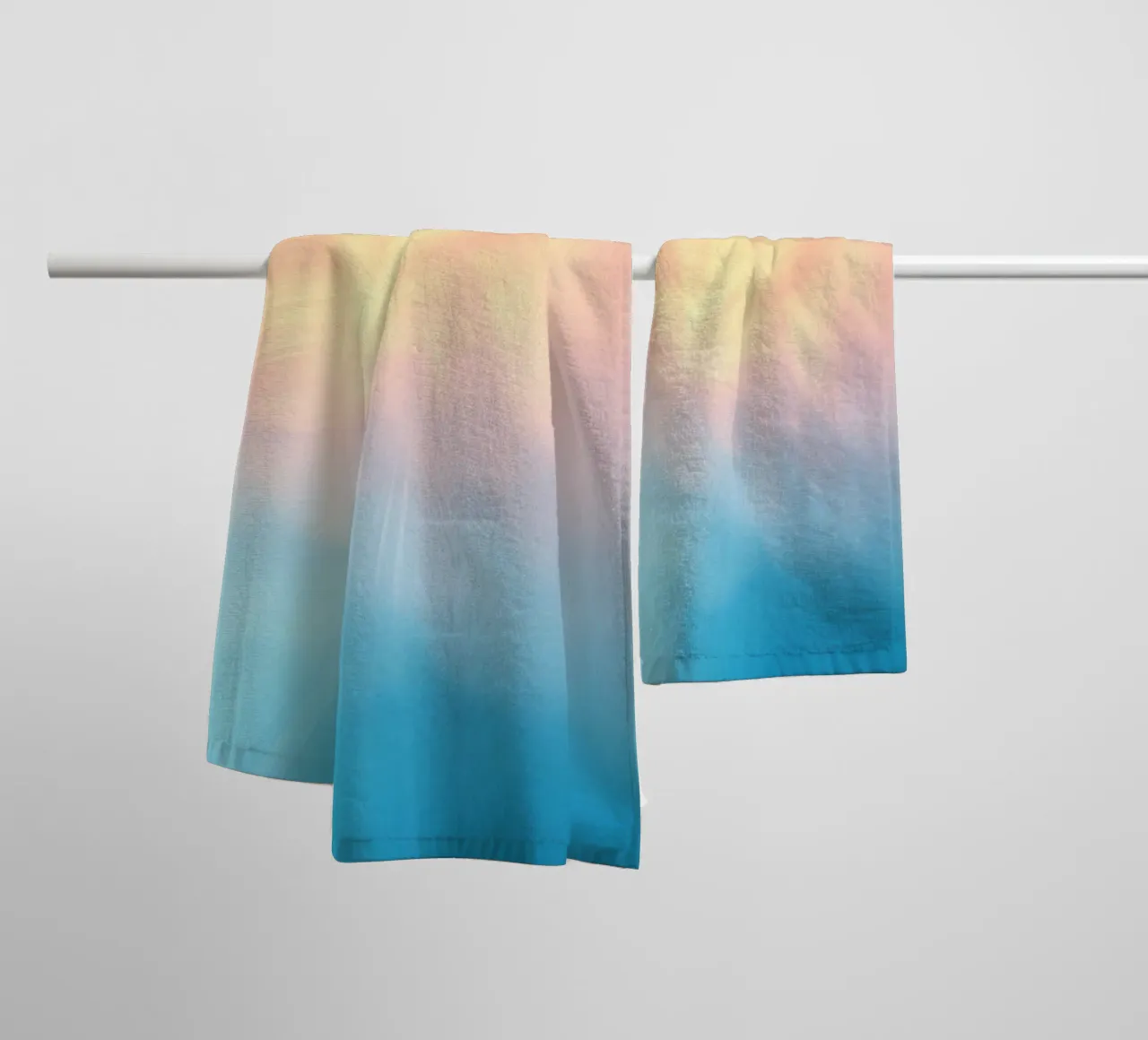 Soft pastel gradient background blending warm pinks and cool towel by DesignDoodle